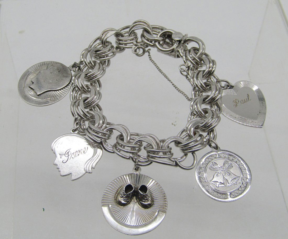vintage, heavy sterling charm bracelet with many charms: nice sterling charm bracelet. weighs 64.5 grams.