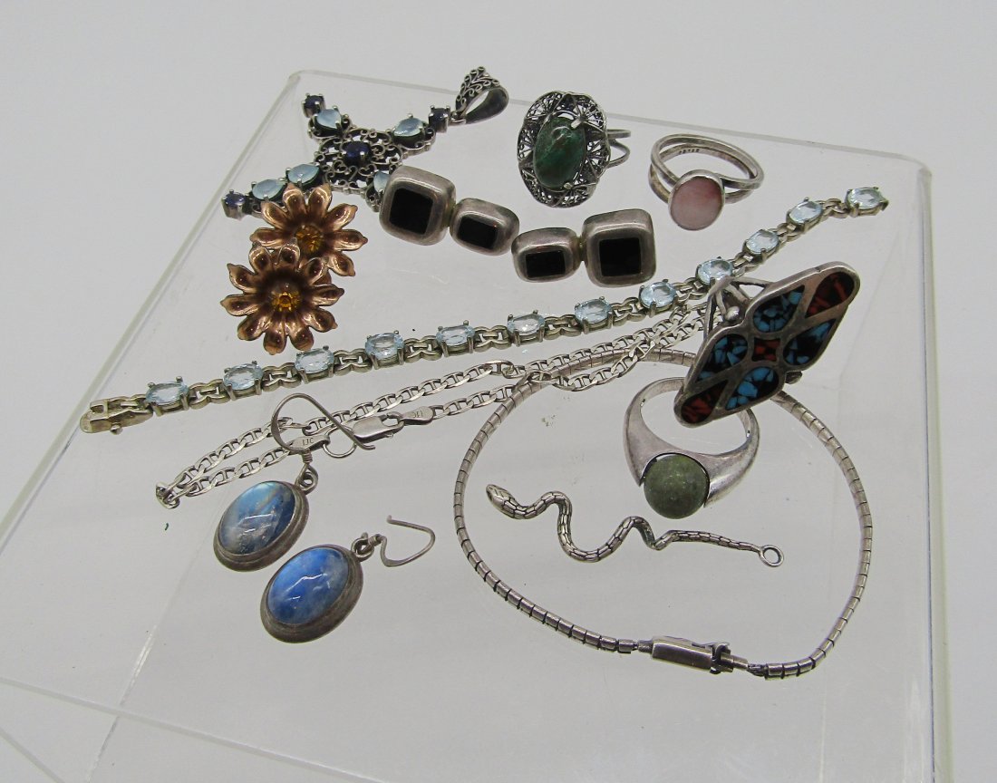 estate lot of sterling jewelry: nice grouping of sterling jewelry to include Cross with aqua stones, tennis bracelet, onyx earrings, rings, etc. 91.5 grams TW.