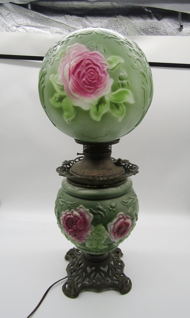 Antique hurricane oil lamp with puffy Roses on body, shade: vintage Hurricane, oil lamp. measures 25" high. body and shade has raised Roses and pattern. metal fittings.