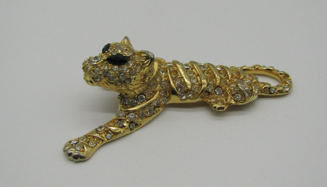 vintage Trifari rhinestone Tiger pin/brooch: marked Trifari gold tone tiger brooch with clear rhinestone, green rhinestone eyes. measures 3".