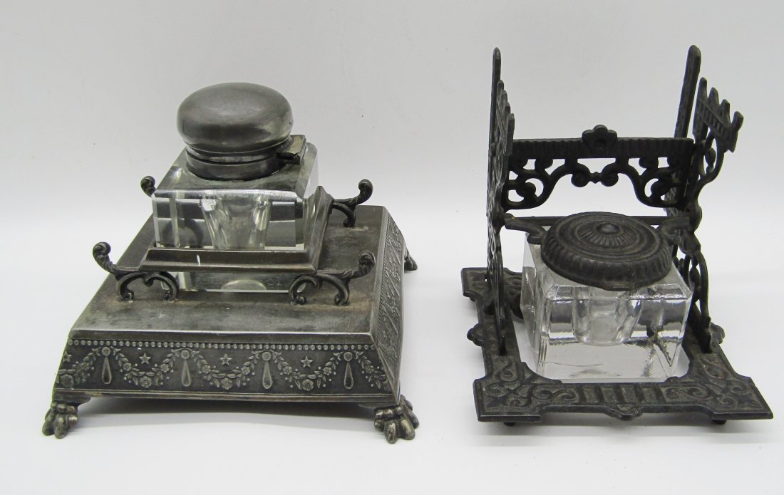 2 Antique inkwells, silverplate and iron holders: 2 antique inkwells. 1 in iron holder with hinged flip top. 2nd in silverplate frame with Lion paw feet. both with glass ink holders.