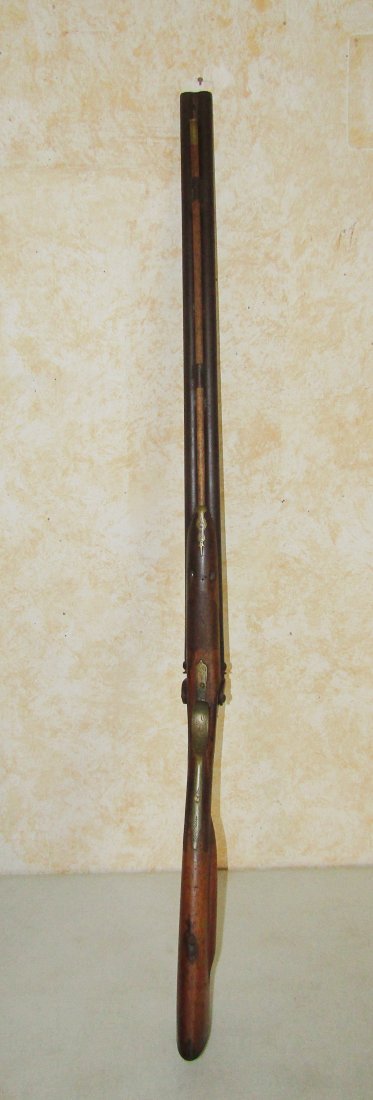 early 19th Century black powder double barrel Shotgun muzzle loader: early 19th Century black powder, muzzle loader, flint lock DBL. barrel shotgun. unknown maker. measures 44". symbol carved in the stock. being sold as found. crack in stock (see photo).
