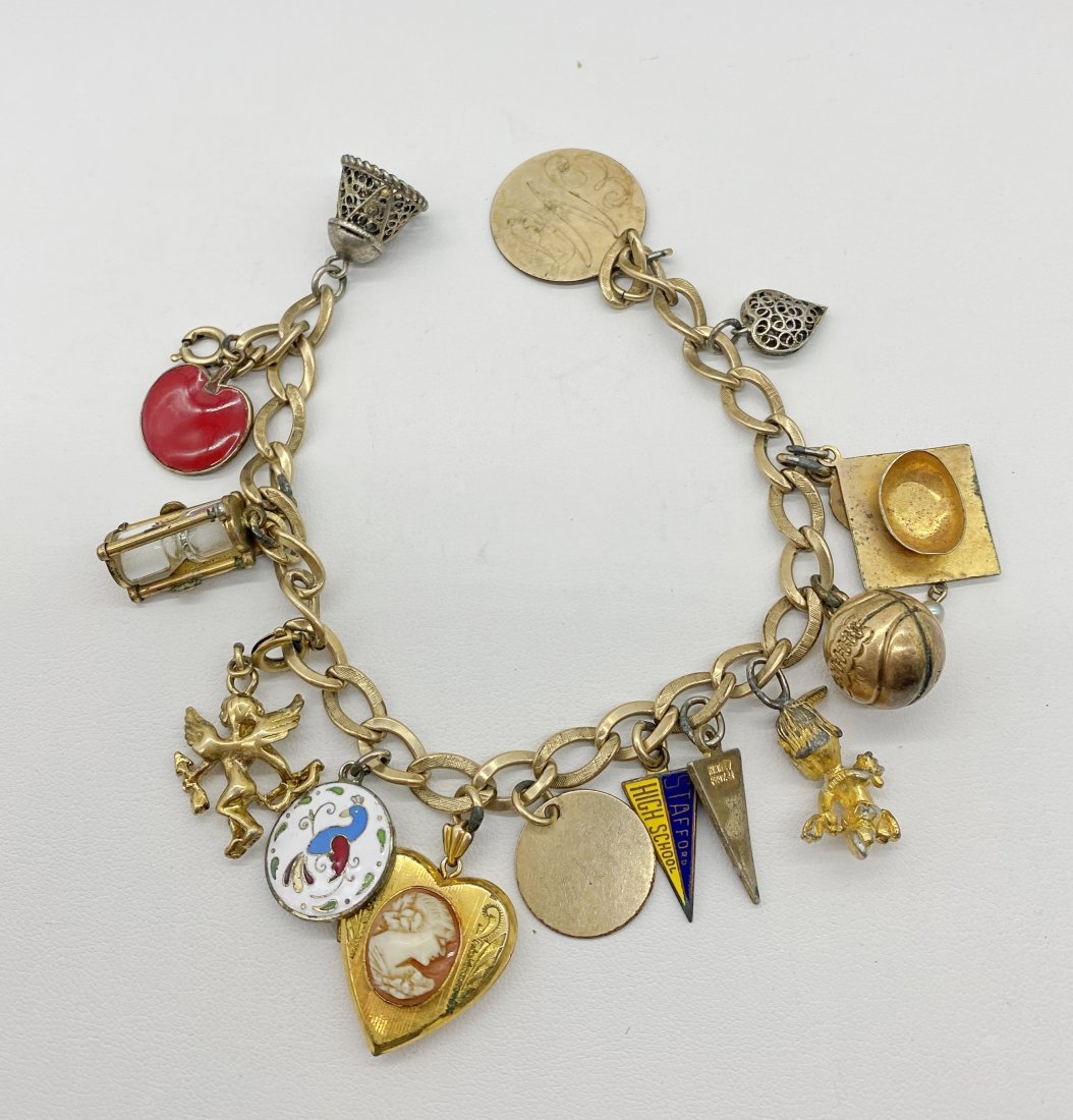 Vintage Gold filled Charm Bracelet with gold filled and gold plate Charms: Vintage 7 inch charm bracelet made with gold filled. Has many gold plate and gold plate charms.