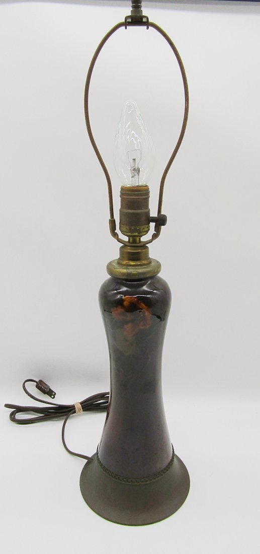 Weller Art Pottery Lamp: Weller Art pottery lamp. body measures 10". dark brown glaze with single flower pattern. overall height 22" to harp.