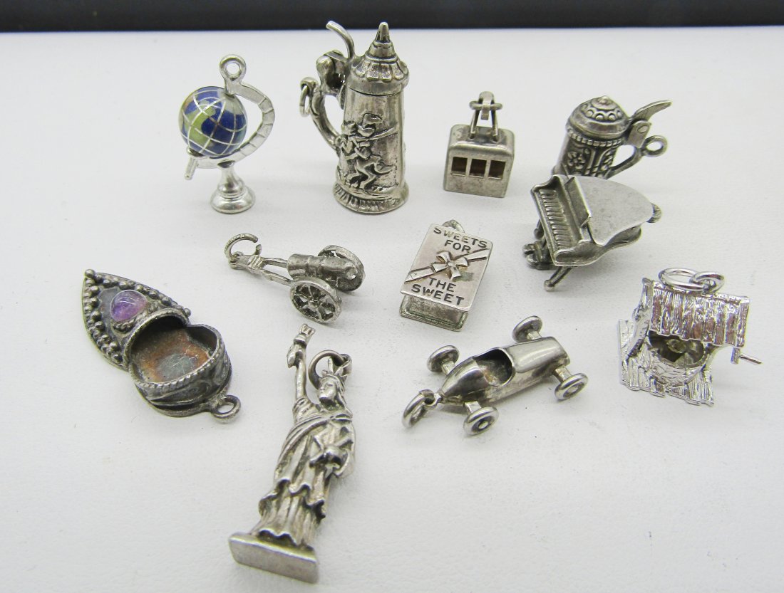 10 vintage sterling charms for charm bracelets: 10 vintage sterling charms to include globe, steins, Lady Liberty, race car, etc.