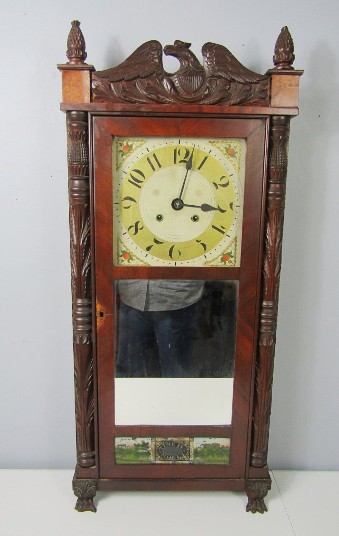 antique Franklin wall clock with Federal eagle pediment: early Franklin Mahogany wall clock with front claw feet, Federal Eagle Pediment, acorn finials. measures 39" high to top of finial by 16" wide. bottom section of door is reverse painted, TIME IS MONEY