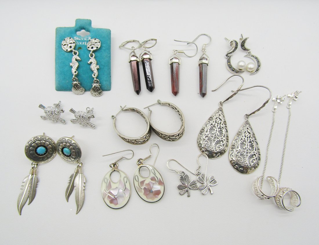 11 pair of estate, sterling earrings: estate lot of 11 pair of sterling earrings o include hoop, Cameo, abalone, etc. 45 grams TW.