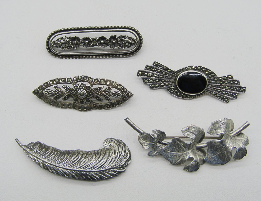 lot of 5 sterling pins: estate lot of 5 sterling pins to include feather, onyx and marcasite etc. 30 grams TW.