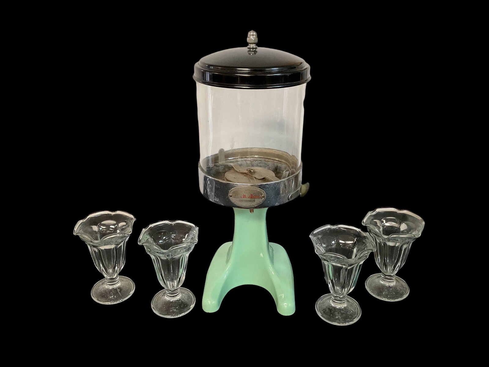 Hamilton Beach Jadeite Malted Milk Dispenser #20 with 4 Sundae Glasses: Hamilton Beach Jadeite Malted Milk Dispenser #20 with 4 Sundae Glasses Measures 18" H Condition good, some pitting on metal rim, small chip on jadeite stand, discoloration on lid