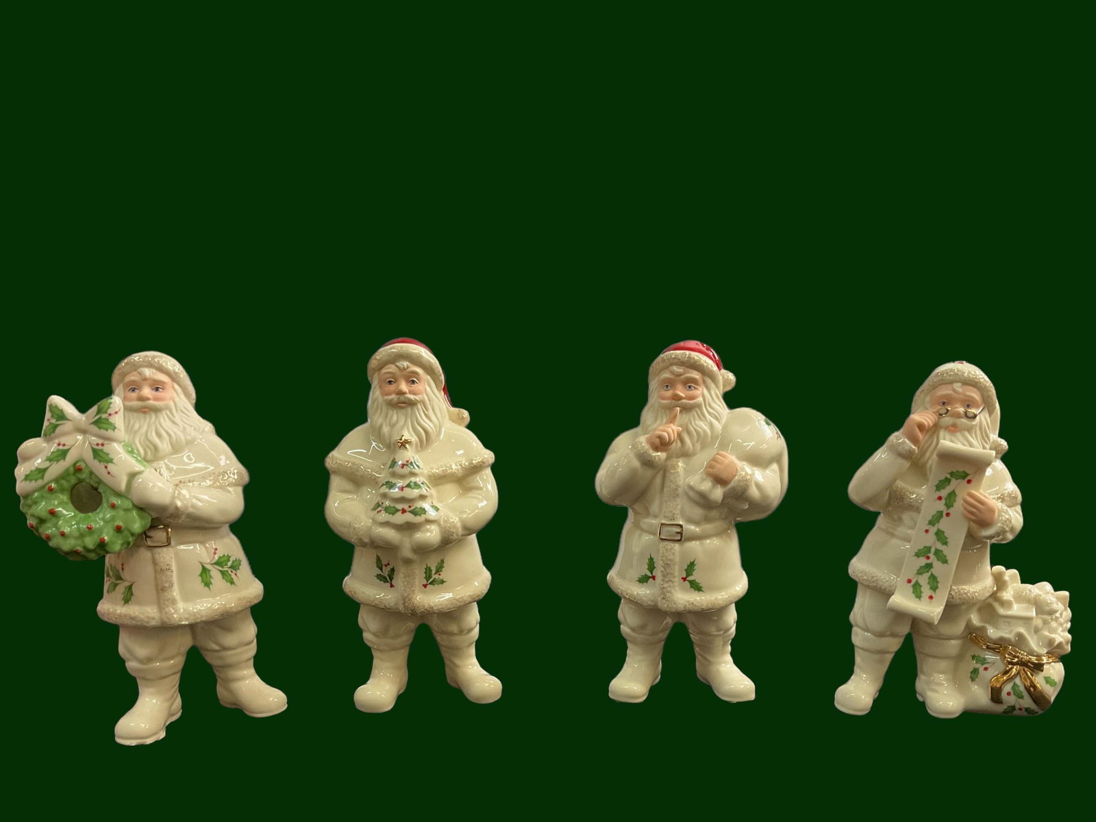 Lot of 4 Holiday Santas by Lenox with boxes: Lot of 4 Holiday Santas by Lenox, Includes: Santa with Wreath, Santa with Tree, Shhâ€¦ Santa, Checking It Twice Santa, with boxes, Height ranges from 6 3/4" - 7 1/2", Condition very good, see phot