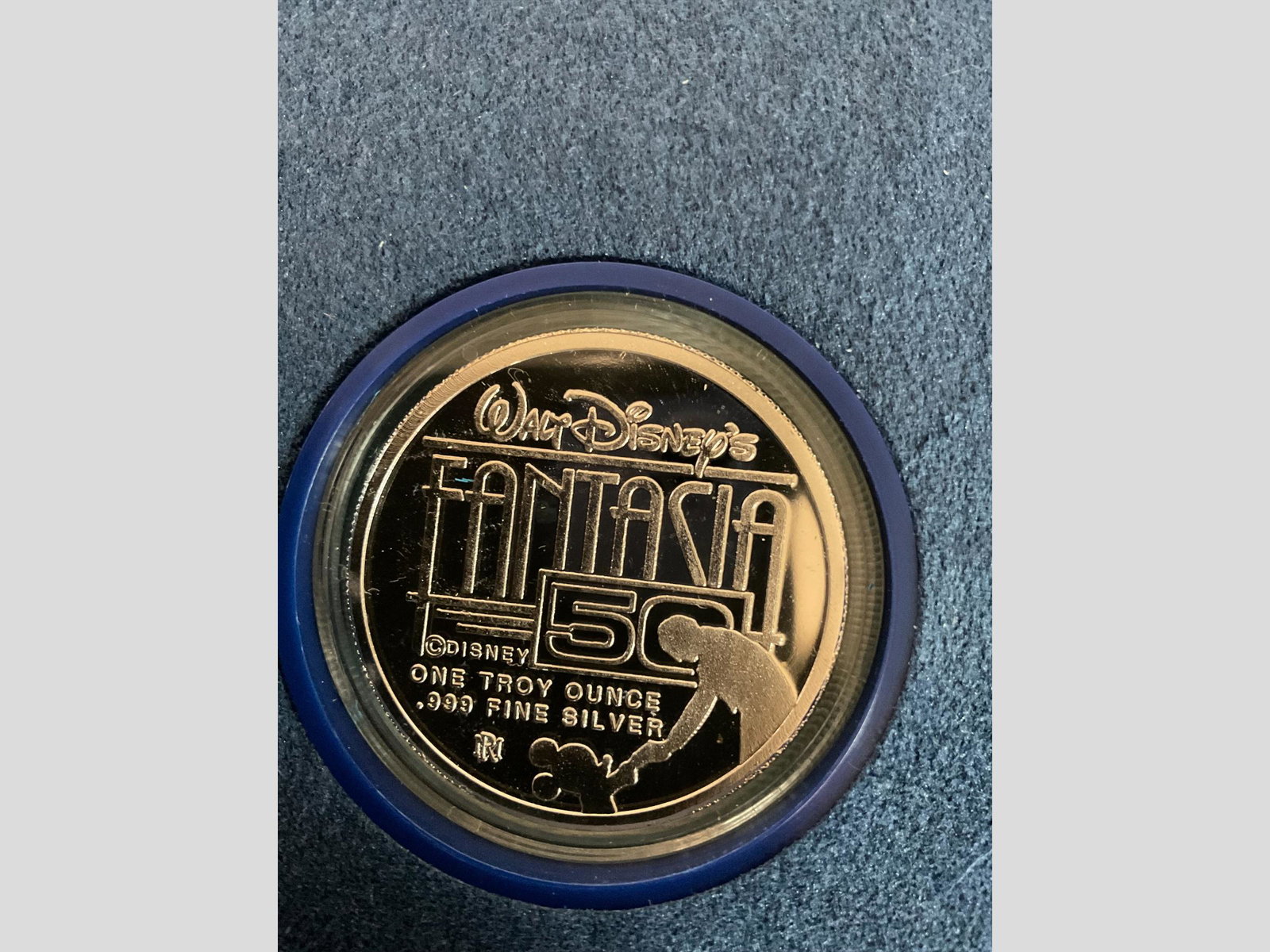 Walt Disney Fantasia 50th Anniversary One Troy Ounce .999 Fine Silver Coin in Display Case: Walt Disney Fantasia 50th Anniversary One Troy Ounce .999 Fine Silver Coin in Display Case, Condition good, note tarnish on front of coin, see photographs