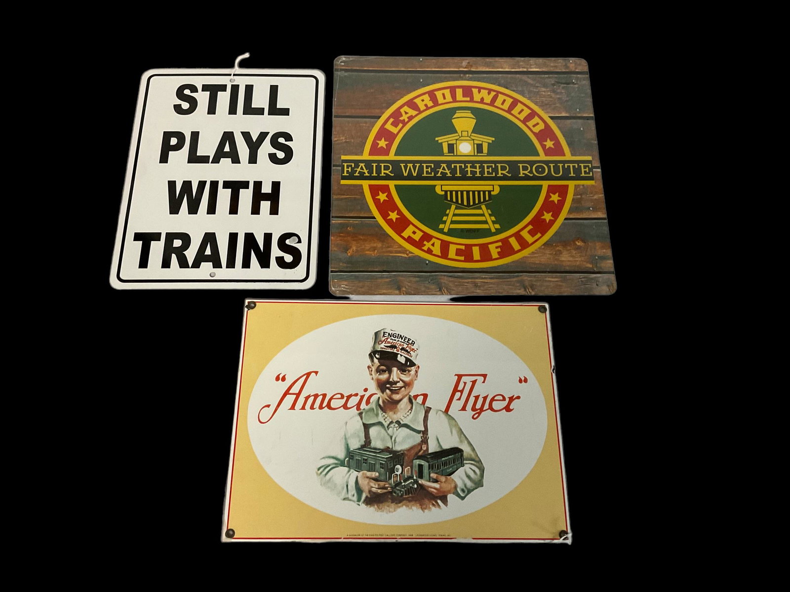 Lot of 3 Metal Signs for Trains--American Flyer, Disney Carolwood Pacific, and Still Plays with: Lot of 3 Metal Signs for Trains--American Flyer, Disney Carolwood Pacific, and Still Plays with Trains, American Flyer is porcelain enameled Measures 9 1/4" high by 12 1/2" wide, Condition: Wear appro