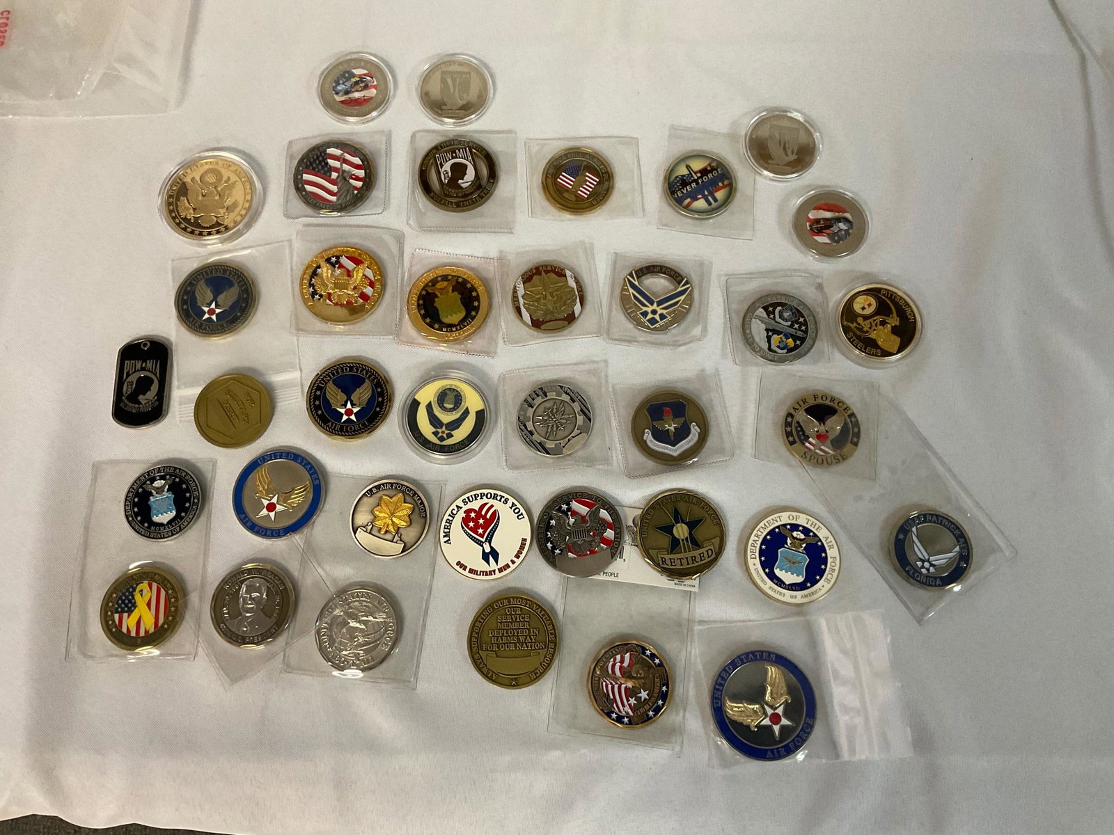 Collection of 36 Challenge Coins: Collection of 36 Challenge Coins, 4 NASCAR, 1 Pittsburgh Steelers, 1 NASA, 8 America, Remembering 911, 22 Military, Condition very good, see photographs