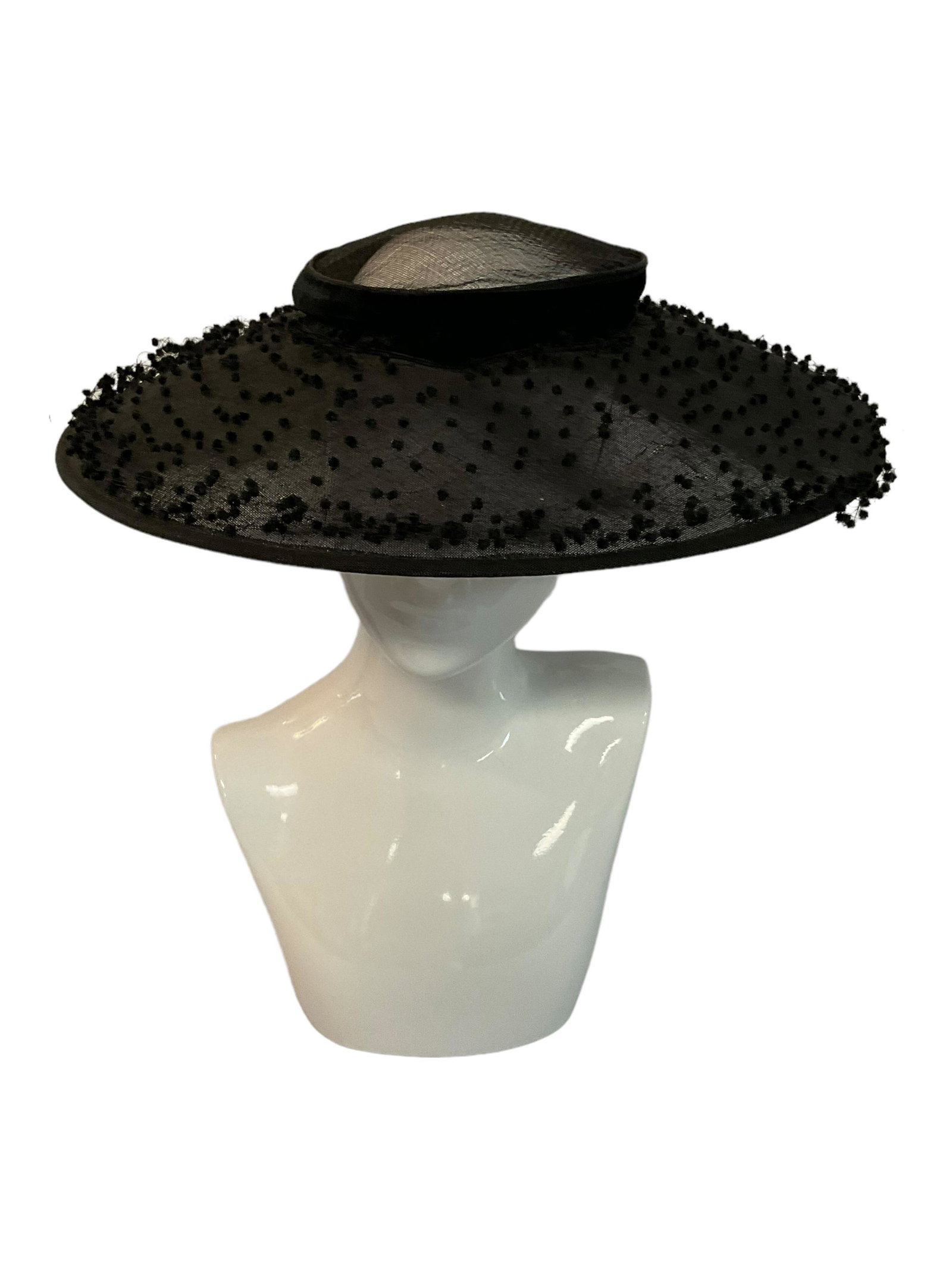 New York Creations Black Woven Nylon Wide Brimmed Hat: New York Creations Black Woven Nylon Wide Brimmed Hat, Circa 1930s, 1940s, Hat covered with dotted velvet netting, Velvet hat band and bow, Opening on top of hat covered by netting, Condition some tea