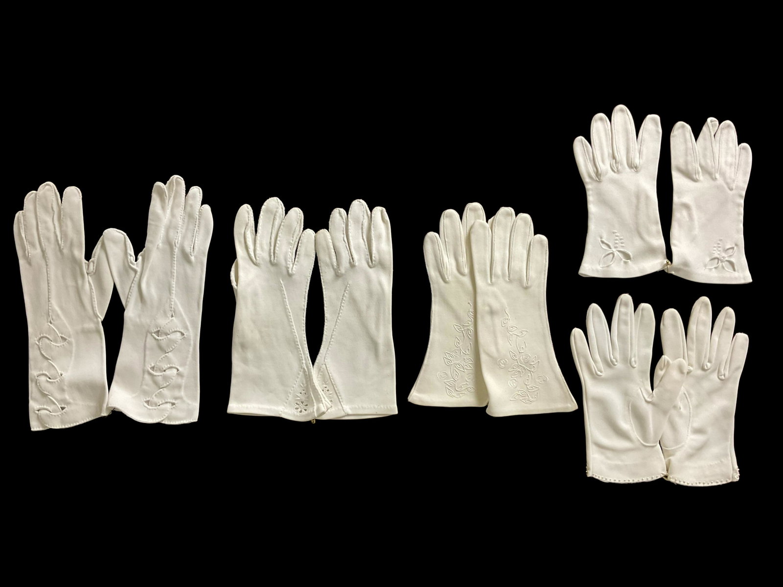 5 Pairs Vintage White Nylon Gloves: 5 Pairs Vintage White Nylon Gloves, Wrist length, No sizes, Various cutout and applied decoration, Condition good, wear consistent with age, see photographs