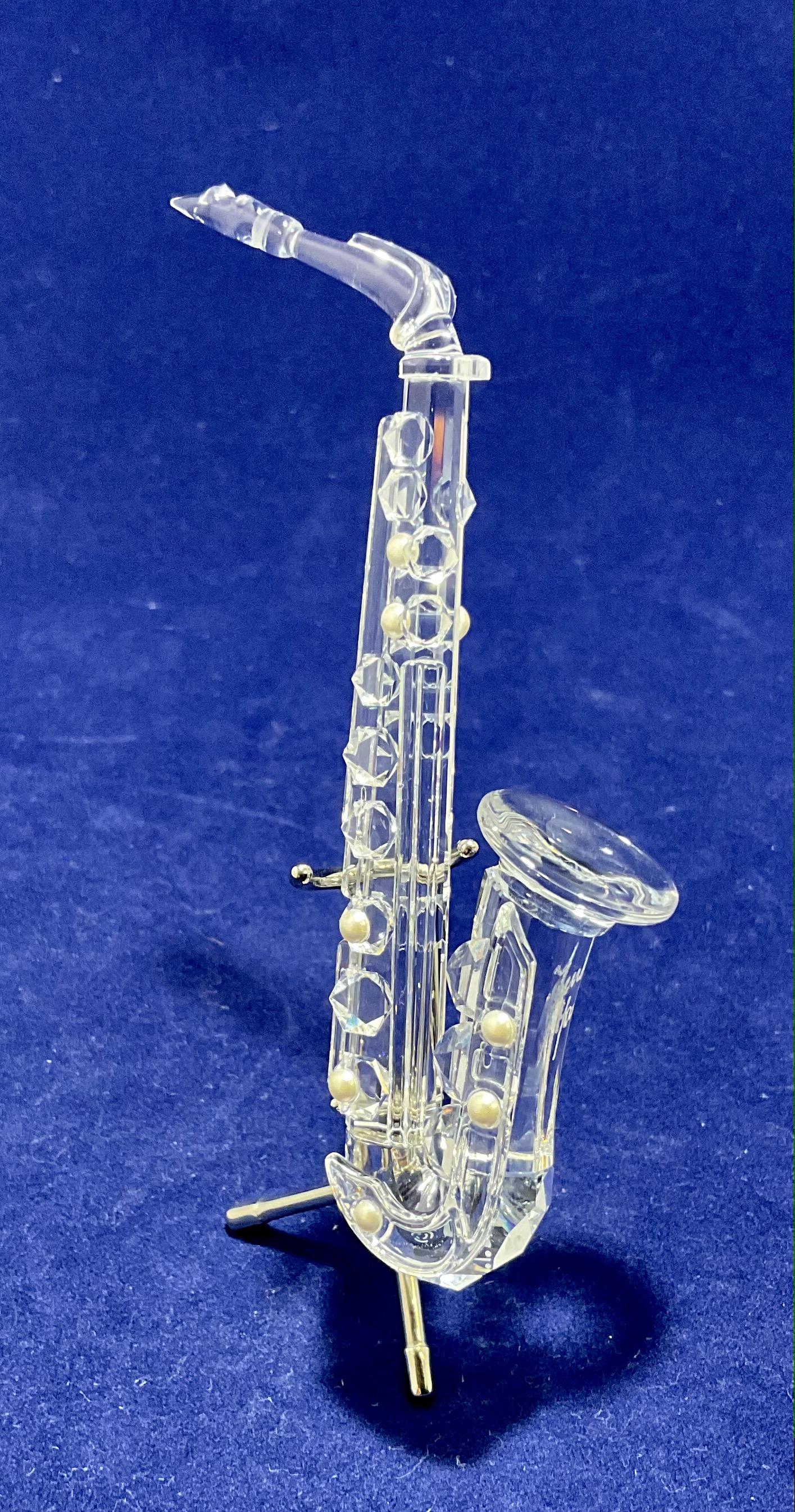 Swarovski Crystal Figurine Saxaphone Number 7477NR000007: Swarovski Crystal Figurine, Saxaphone, Number 7477NR000007, Signed, With Box, Measures 4", Condition very good, see photographs