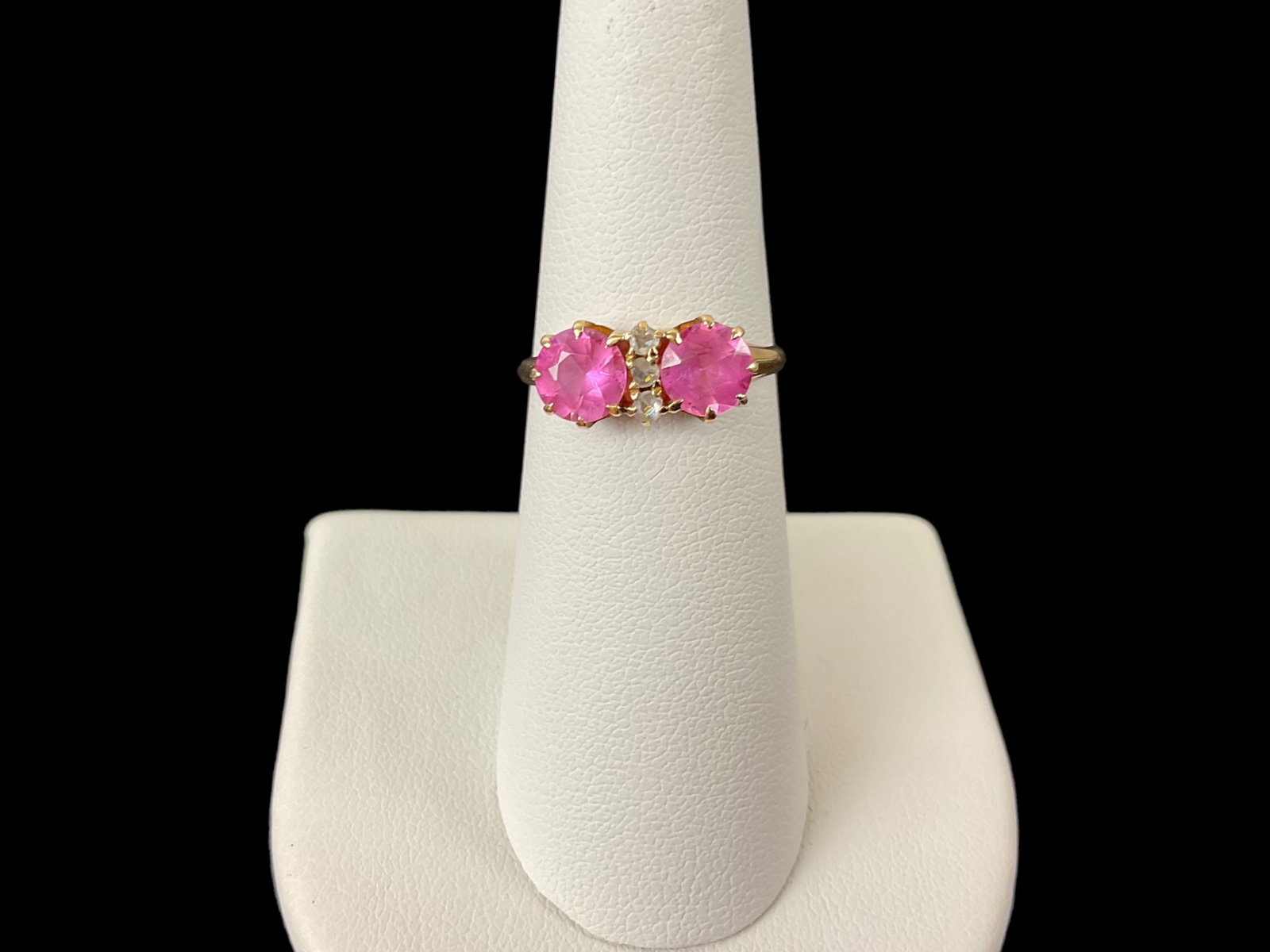 14K Yellow Gold Pink Sapphire and Diamond Ring: 14K Yellow Gold Pink Sapphire and Diamond Ring. The contains 2 round pink sapphires measuring approximately 6.12 mm and 3 round diamonds measuring approximately 1.76 mm. The ring is stamped "MMM" or "
