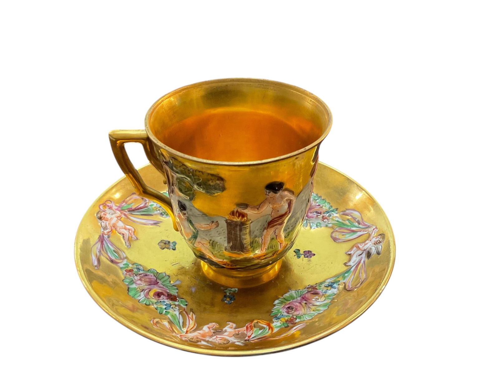 Capodimonte Gilded Porcelain Demitasse Cup and Saucer: Capodimonte Gilded Porcelain Demitasse Cup and Saucer, Late 19th century, Made in Italy, Saucer approximately 4 1/2” D, cup approximately 2 1/4” H, and 2 3/4” W, Condition, good for