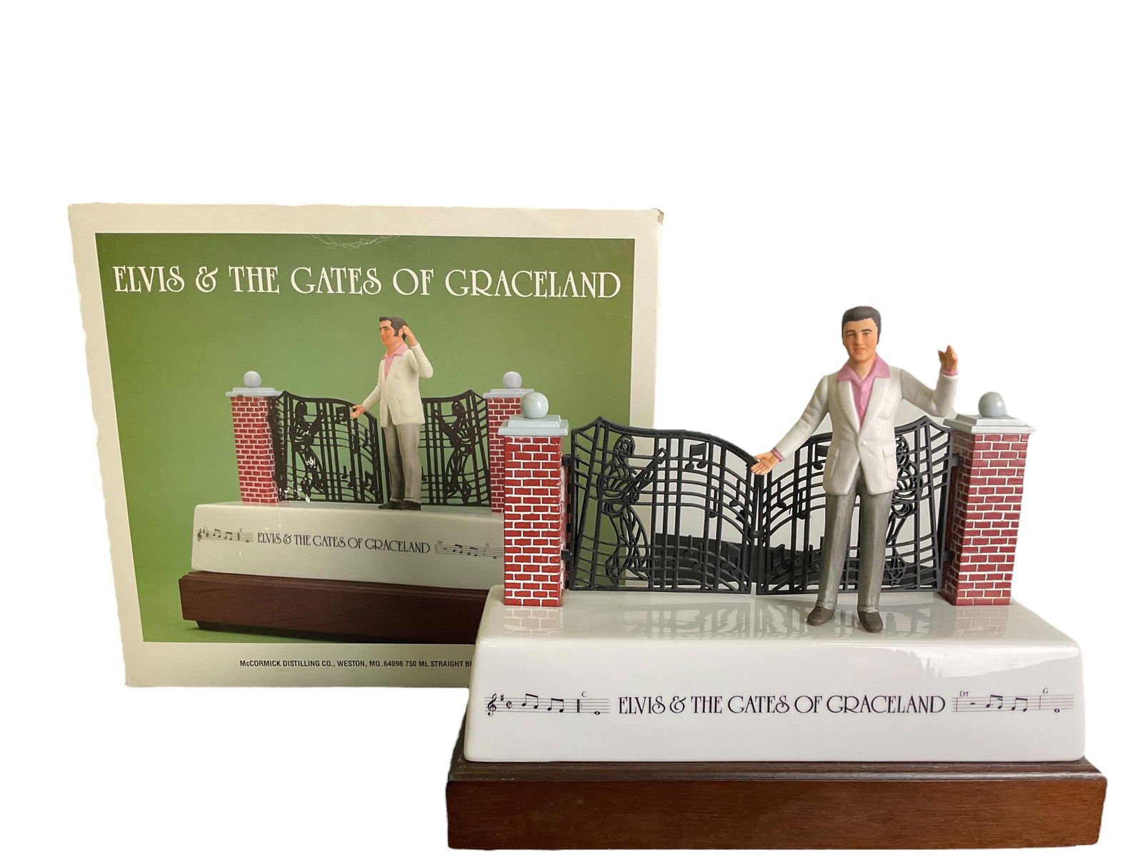 Elvis & The Gates Of Graceland McCormick Decanter Music Box: Elvis & The Gates Of Graceland McCormick Decanter Music Box, Empty decanter, original box in fair condition, Music Box works, 9" tall, 11" wide, Condition, see photographs
