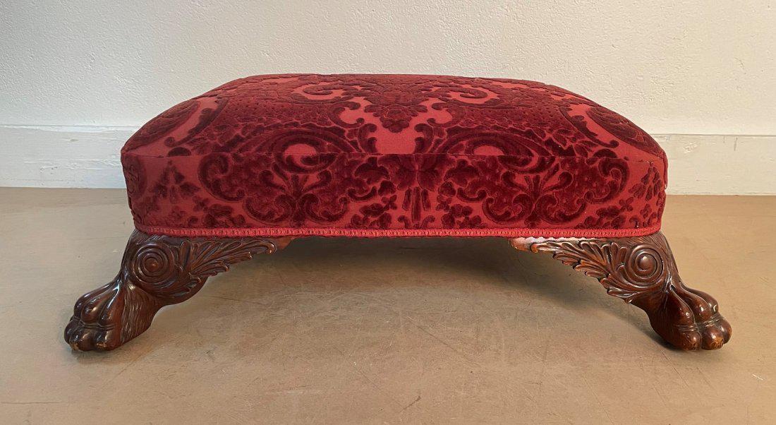 Antique Style Mahogany Footstool: Antique Style Mahogany Footstool. Carved mahogany feet with velvet upholstery. Measures: 10.5H x 29W x 23D