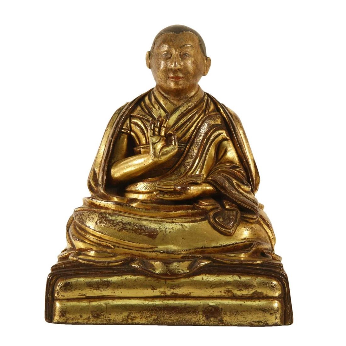 A Gilt-Bronze Figure Of Brog.Mi: A Gilt-Bronze Figure Of Brog.Mi. Seated on a base with a peaceful expression, body rendered clad in a robe, the voluminous drapery elegantly cascading in folds. 17th Century. Size:13cmx11cmx16cm