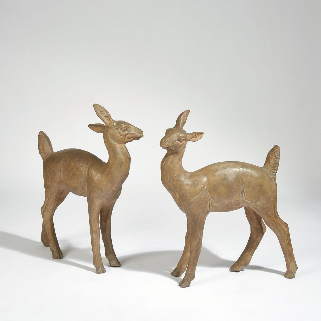 MARIUS GIUGE (1909-1980): MARIUS GIUGE (1909-1980) Suite de deux faons en terre cuite patinée. Signature d'un cachet "Marius Giuge Vallauris" A patinated terra cotta set of two fawns. Stamped. H 75 x L 67 cm - H 29 1/2 x