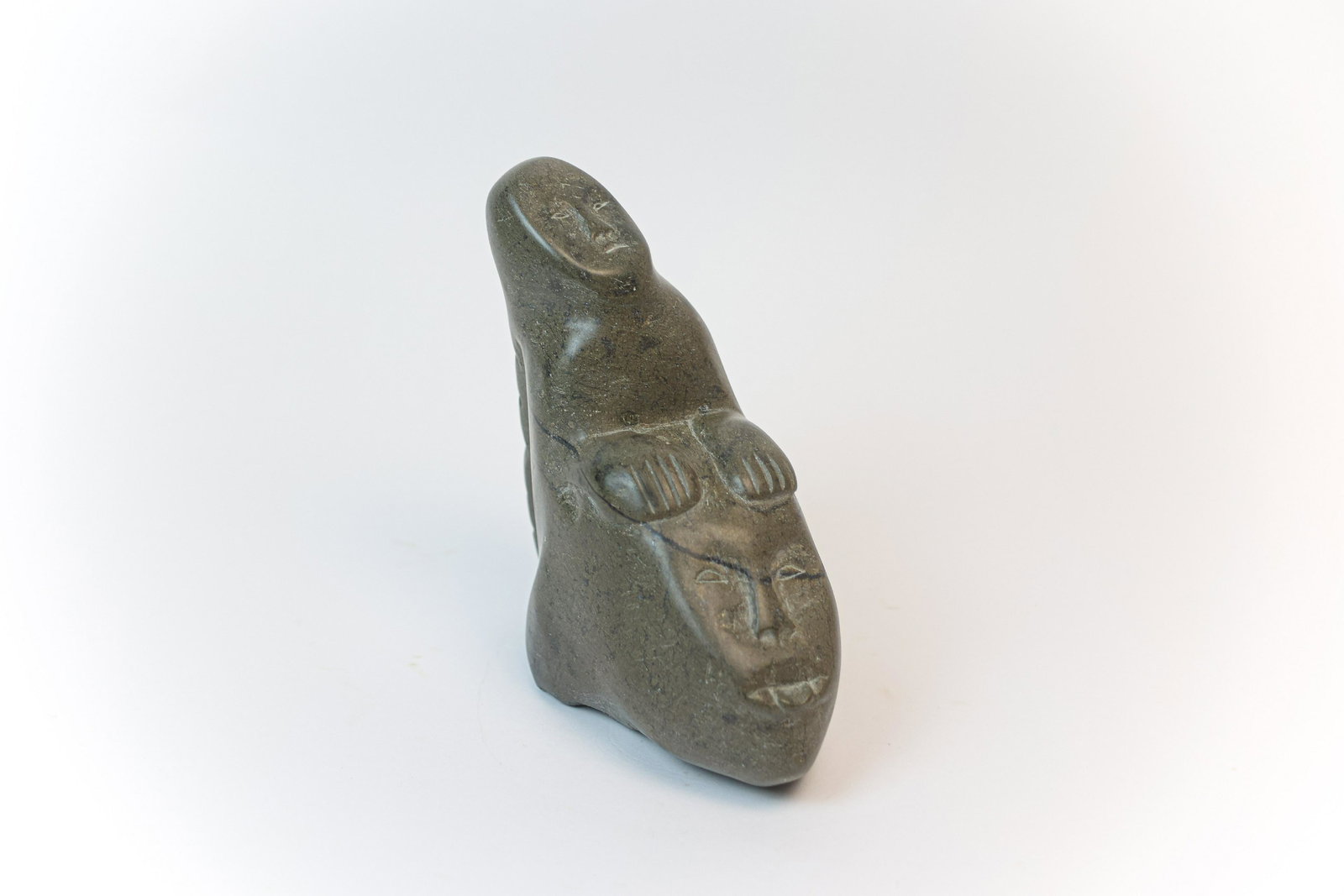 Inuit Man Holding Face Soapstone Sculpture (1 of 9)