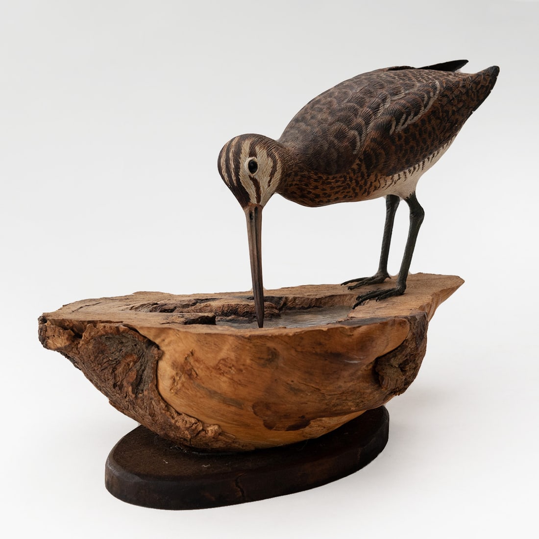 Hand Carved Eurasian Whimbrel: Hand Carved Eurasian Whimbrel Mounted on driftwood base with resin pond with shells, etc. NOTE: the wood base has the initials "WHP or JHN". Cannot find artist associated with these initials.