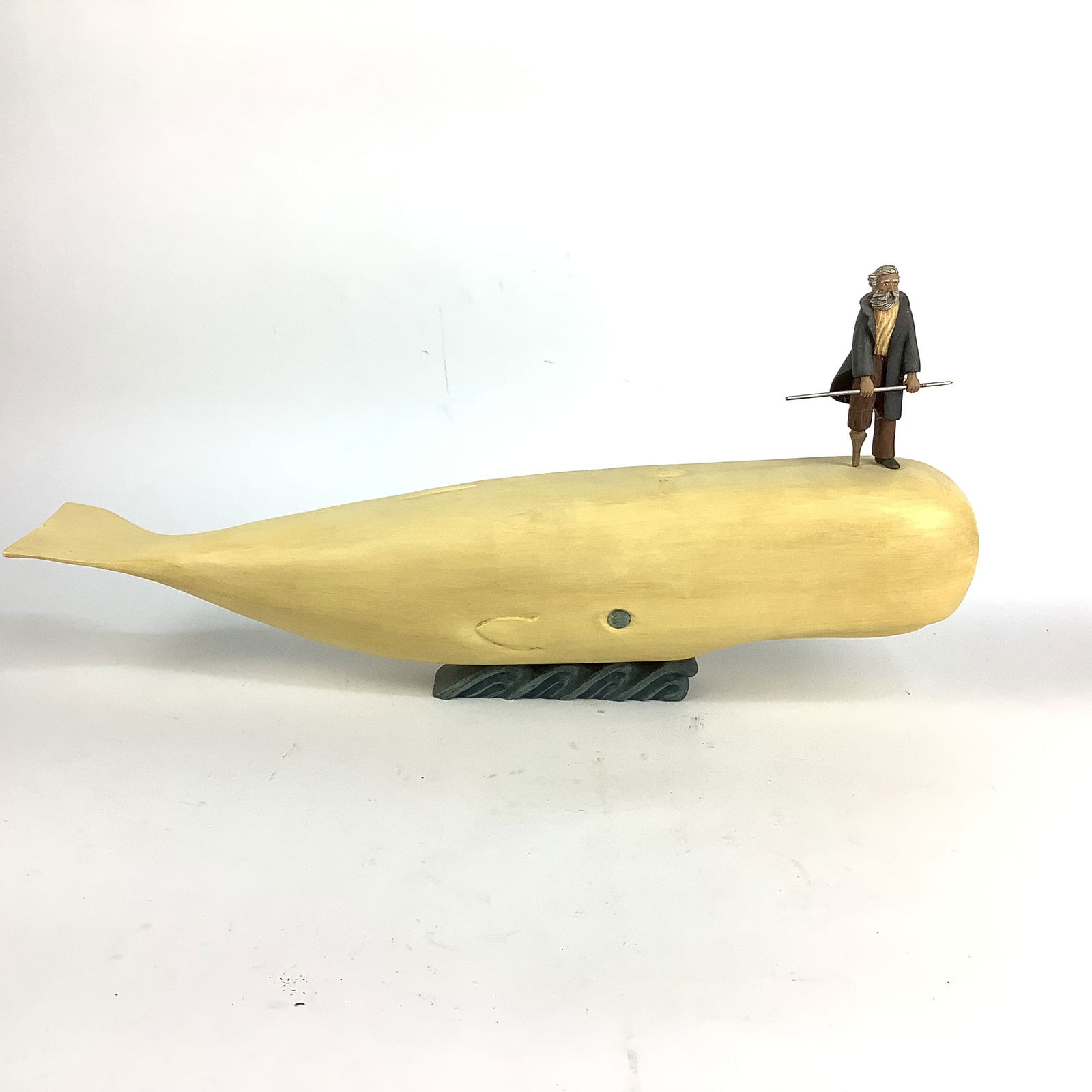Handcrafted Folk Art Moby Dick & Captain Ahab: Vintage hand carved and hand painted sculpture of Captain Ahab with spear and a plank leg standing on Moby Dick. Measurements 32"wide x 10.25"high x 4.25"depth.