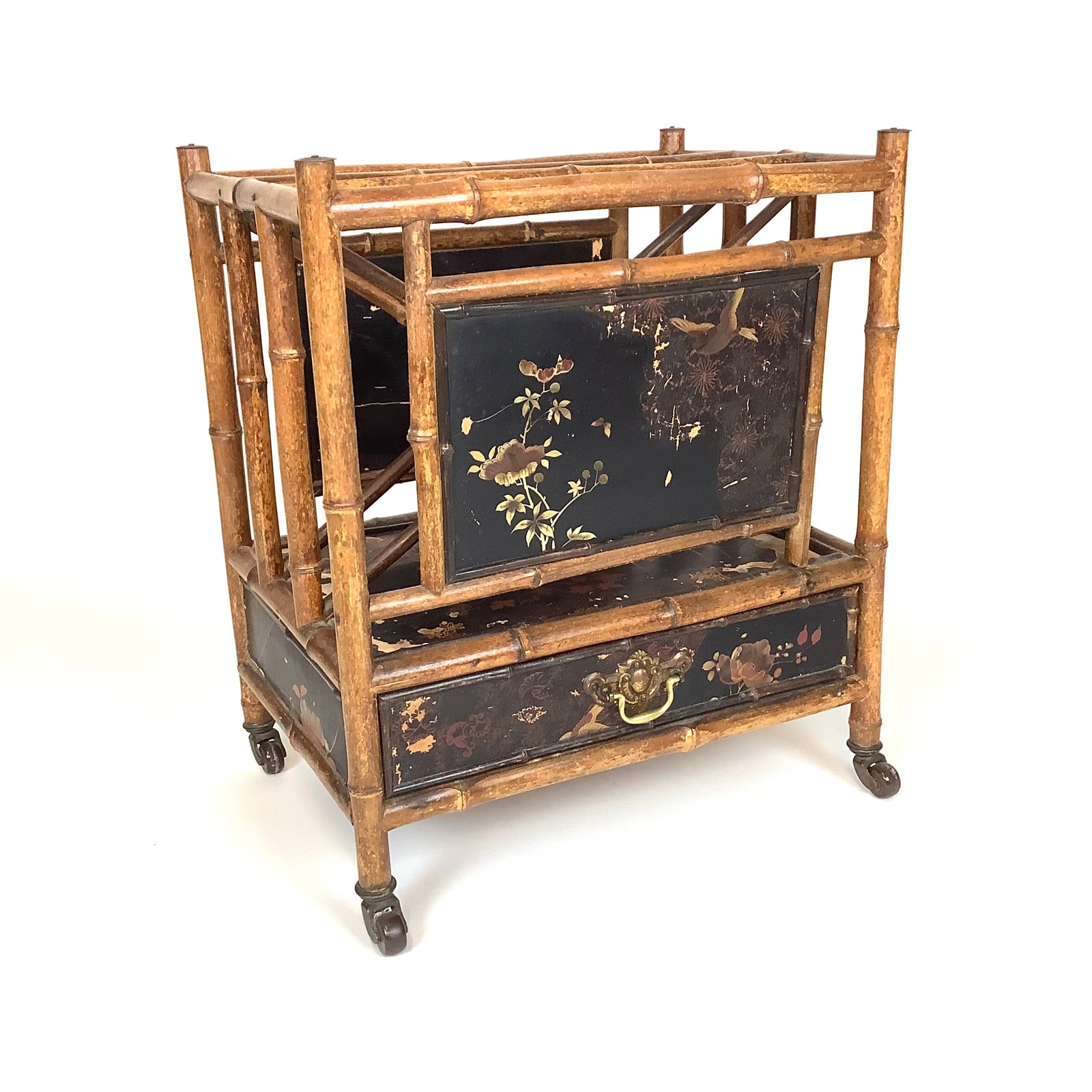 Antique English Bamboo Canterbury with Japanning Finish: beautiful bamboo Canterbury with floral and bird japanning finish. Signs of wear due to age and structurally sound. Brass top finials , pull and castors with single drawer. measuring 23.5" high x 14.2