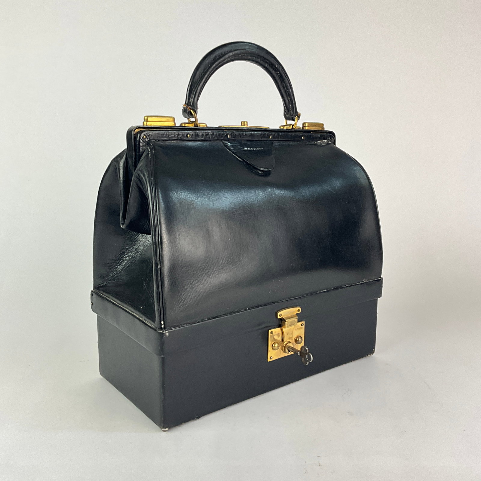 Hermés 'Sac Mallette' Handbag: Hinged Compartment at the base acting as a jewelry case. Top compartment opens with two sliding latches. Includes Key. Handlestrap was once ripped and re-gluedMeasurements:10.5" in length, 9.5" in hei