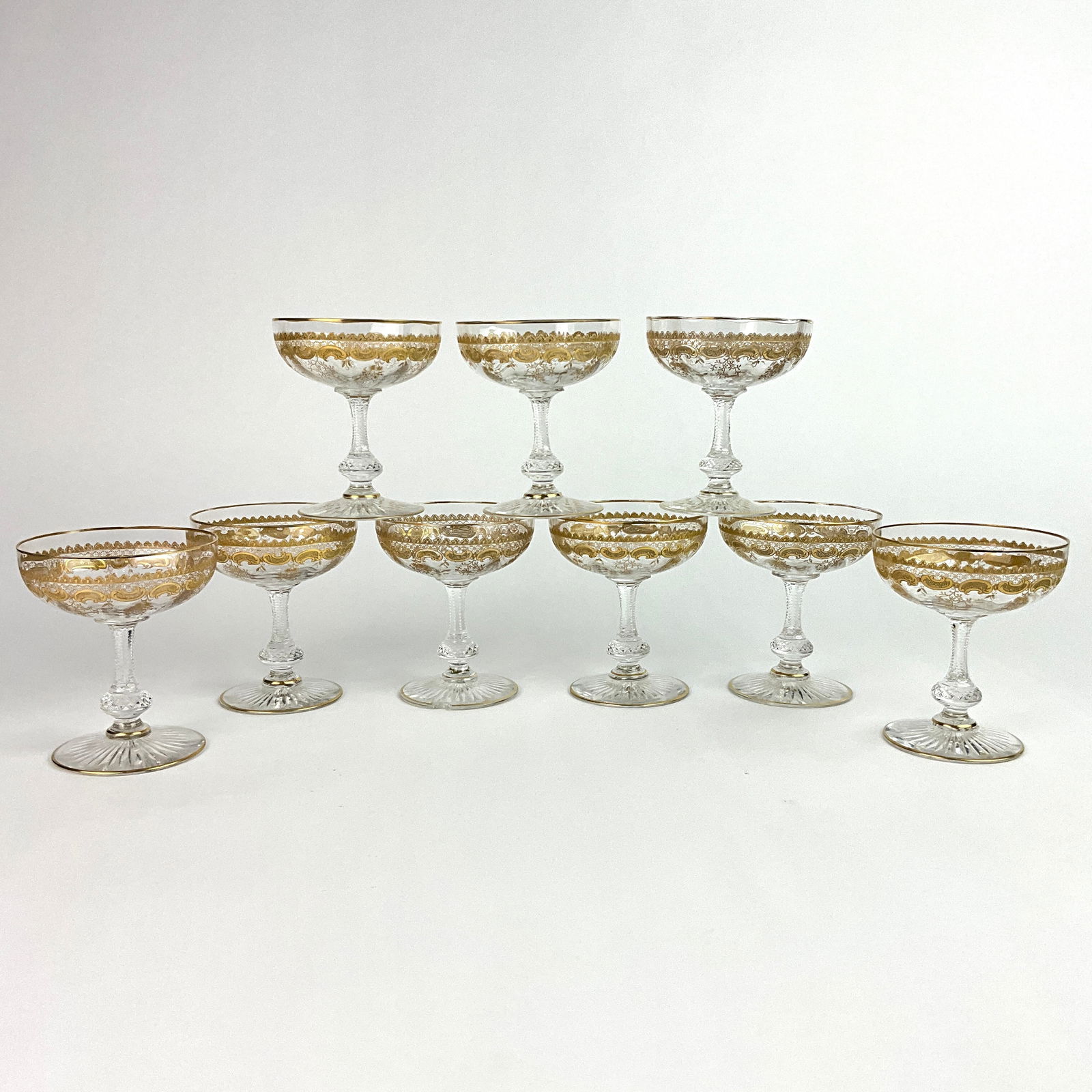 9 Saint Louis Massenet Gold Champagne Tall Sherbet Blown Glasses: 9 saint Louis Massenet clear gold encrusted wine glasses. gold encrusted foliate and floral design to bowls with gilt accents. cut glass knobbed stem, and star cut foot.Measurements:4" in height, 3.5"