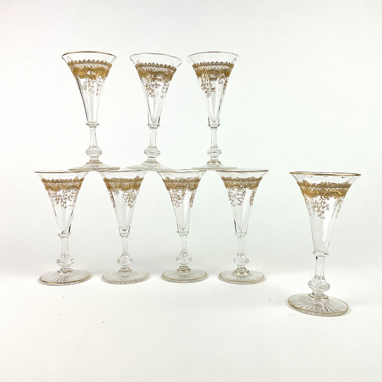 8 Saint Louis Massenet Clear Gold Encrusted Wine Glasses: Gold encrusted foil and floral design to bowls with gilt accents, cut glass knobbed stem, and a start cut foot.Measurements:4.75" in height, 2.25" in width