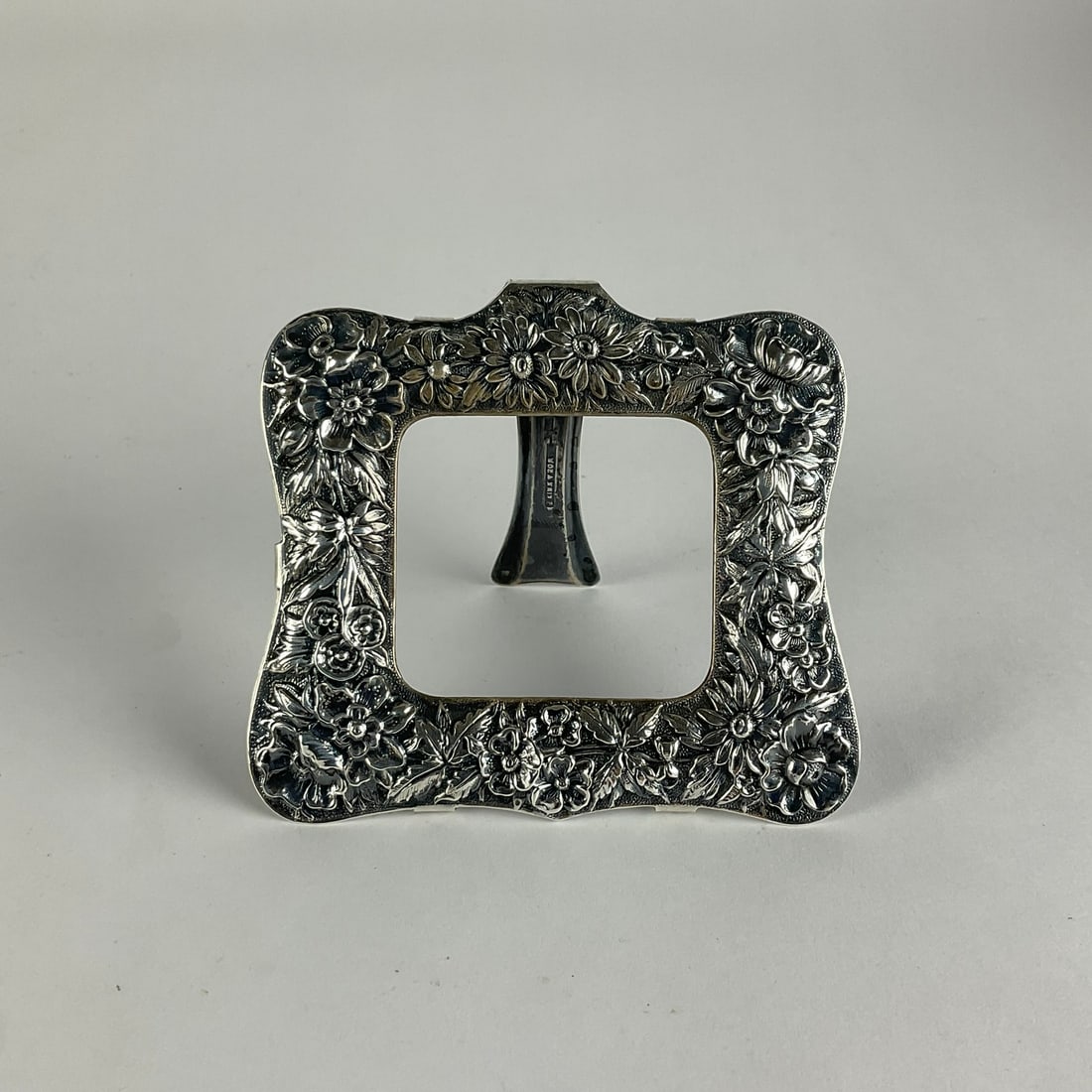S.Kirt & Sons .925 Sterling Repousse Calender Photo Frame: 1.4 oz. Measures: 3.75" wide x 3.25" high. Has no back or glass.
