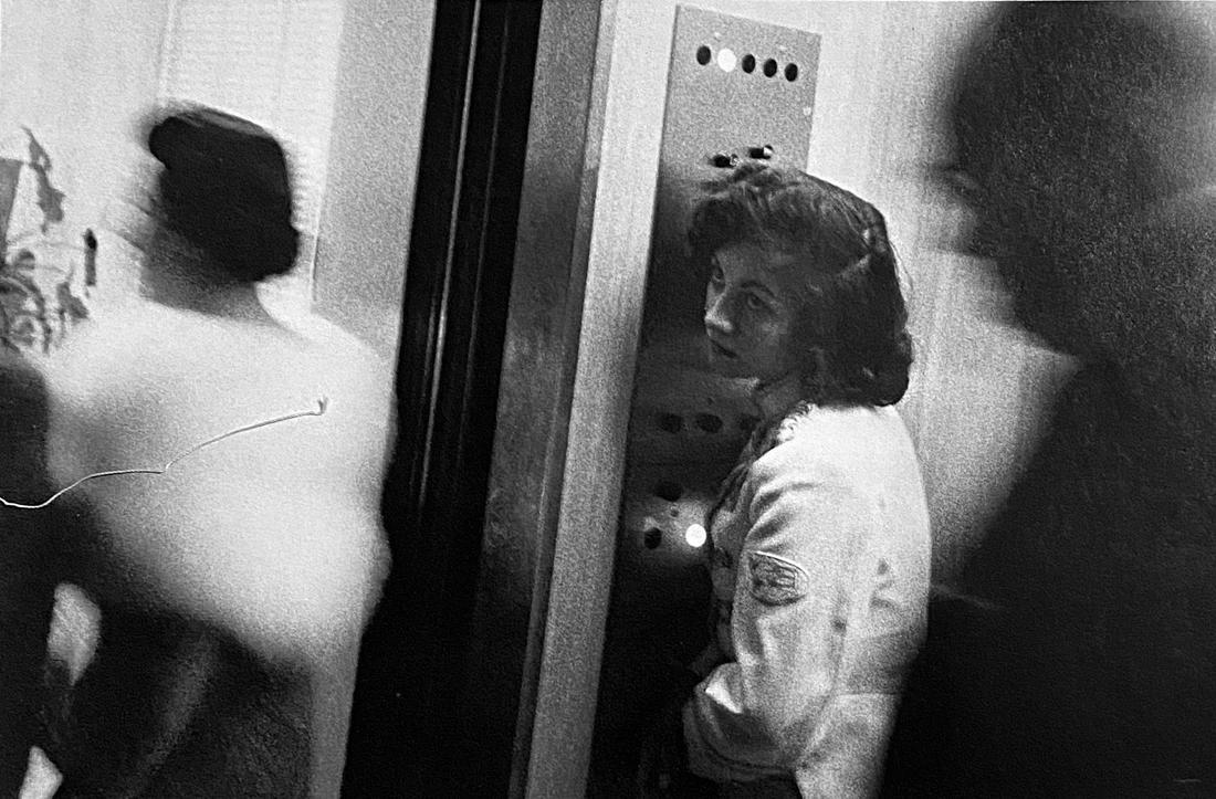 Robert Franks, Elevator- Miami Beach: Photographer: Robert Frank (1924-2019) was a Swiss photographer and documentary filmmaker, who became an American binational. His most notable work, the 1958 book titled The Americans, earned Frank co