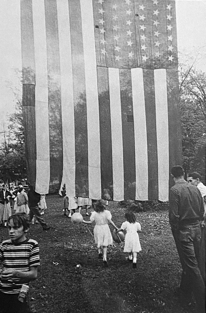 Robert Franks, Fourth of July- Jay, New York: Photographer: Robert Frank (1924-2019) was a Swiss photographer and documentary filmmaker, who became an American binational. His most notable work, the 1958 book titled The Americans, earned Frank co