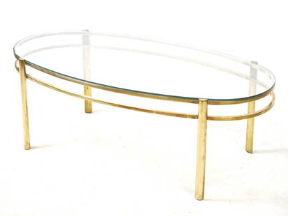 Jacques QUINET (1918-1992) pour la maison Malabert : Table basse a plateau en verre transparent,: Jacques QUINET (1918-1992) pour la maison Malabert : Table basse a plateau en verre transparent, pietement en bronze a double ceinture entre quatre pieds. Signe. N° et annote Broncz. H 36 - L 100 -
