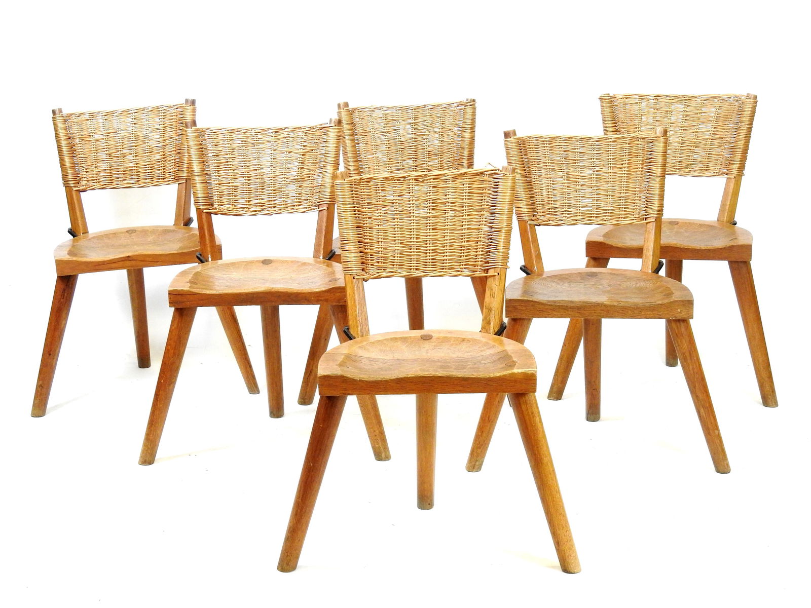 LES ARTISANS DE MAROLLES & DE LOIR ET CHER sous la direction artistique de Jean TOURET (1916-2004):: LES ARTISANS DE MAROLLES & DE LOIR ET CHER sous la direction artistique de Jean TOURET (1916-2004): Six chaises en chene, assise travaillee en nid d'abeilles a l'aide d'une herminette, le dossier tend