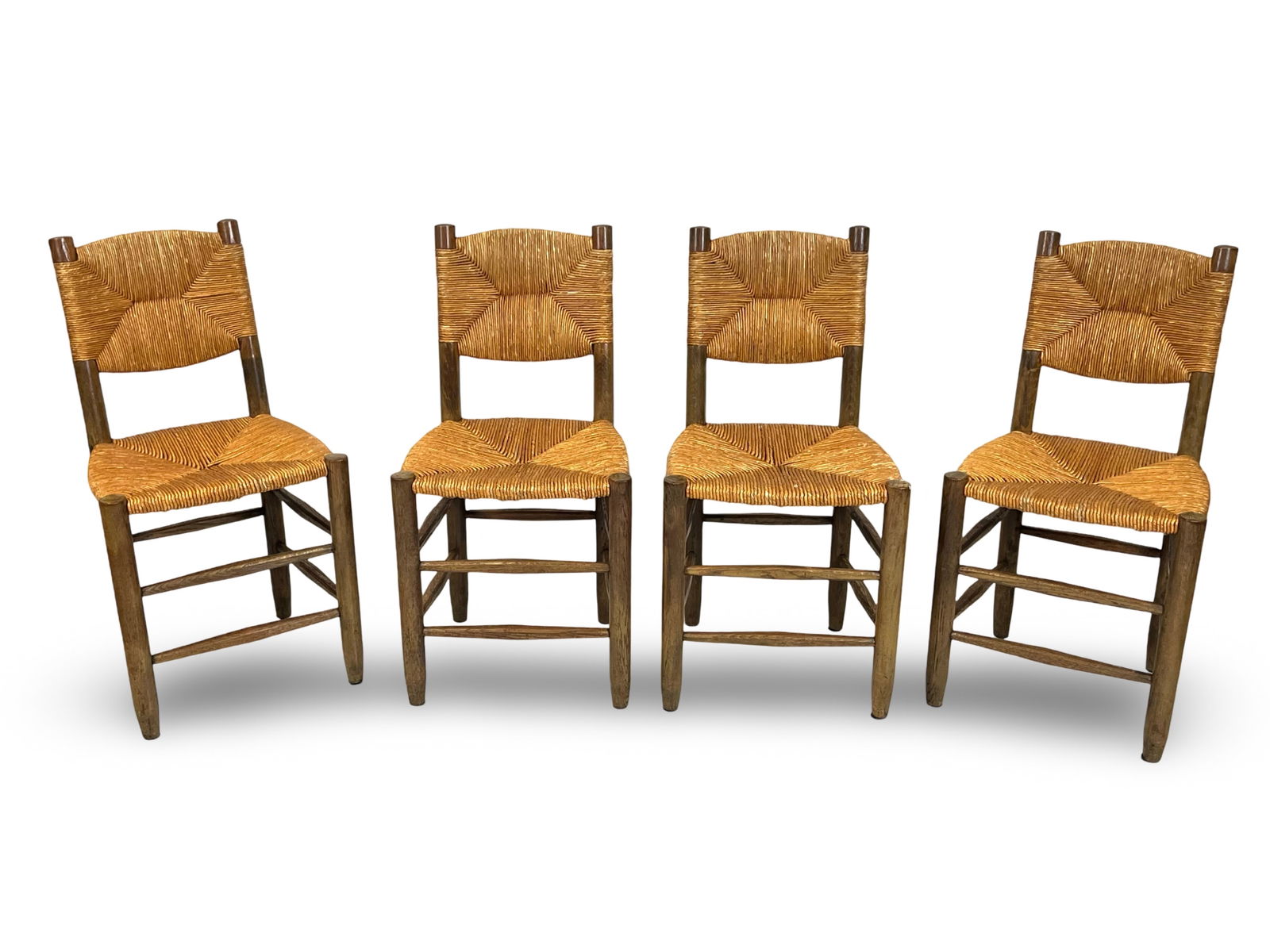 Charlotte PERRIAND (1903 - 1999) Quatre chaises dite "Bauche n° 19" en frene et paille. 82 x 44 x: Charlotte PERRIAND (1903 - 1999)Quatre chaises dite "Bauche n° 19" en frene et paille.82 x 44 x 44 cmBibliographie :- Charlotte Perriand, L’OEuvre complete, Vol.3 : 1956-1968, J. Barsac, Ed. Norma,