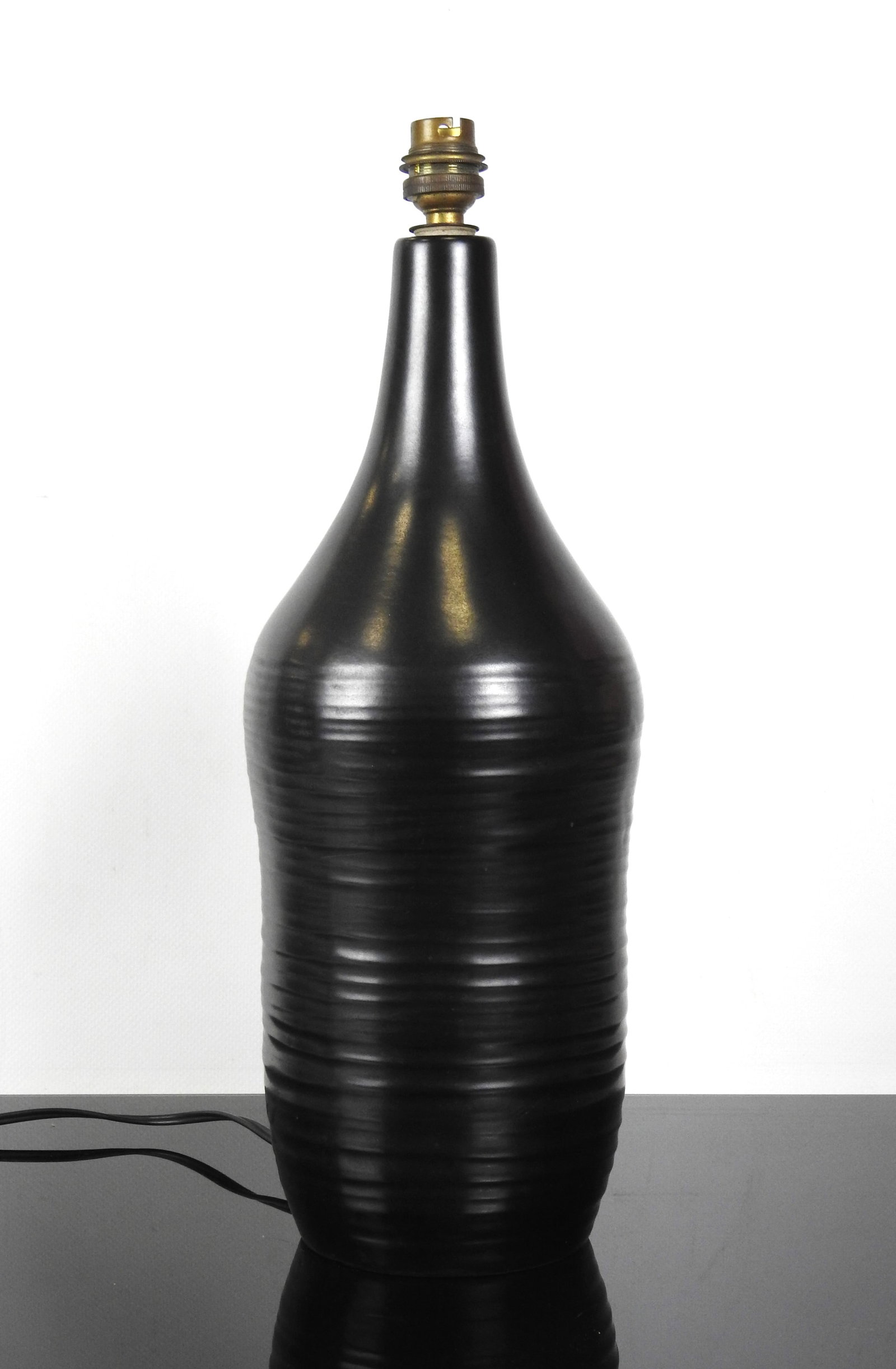 Georges JOUVE (1910-1964) (dans le gout) Lampe en: Georges JOUVE (1910-1964) (dans le gout) Lampe en ceramique a glaçure noire en forme de bouteille. Signe HOHauteur (ceramique) : 39 cm - Hauteur totale avec abat-jour : 68 cm