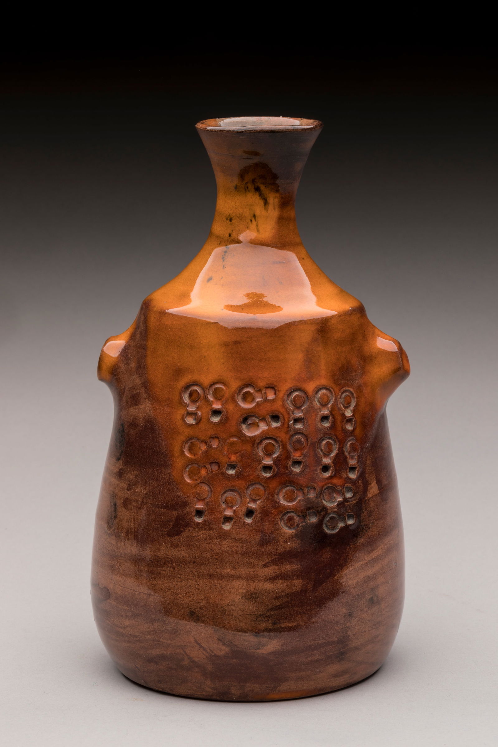 Juliette DEREL (1918-2007) Vase a epaulement en fa: Juliette DEREL (1918-2007)Vase a epaulement en faïence a couverte les teintes orangees a decor estampe.Signe au reversH. : 17 cm