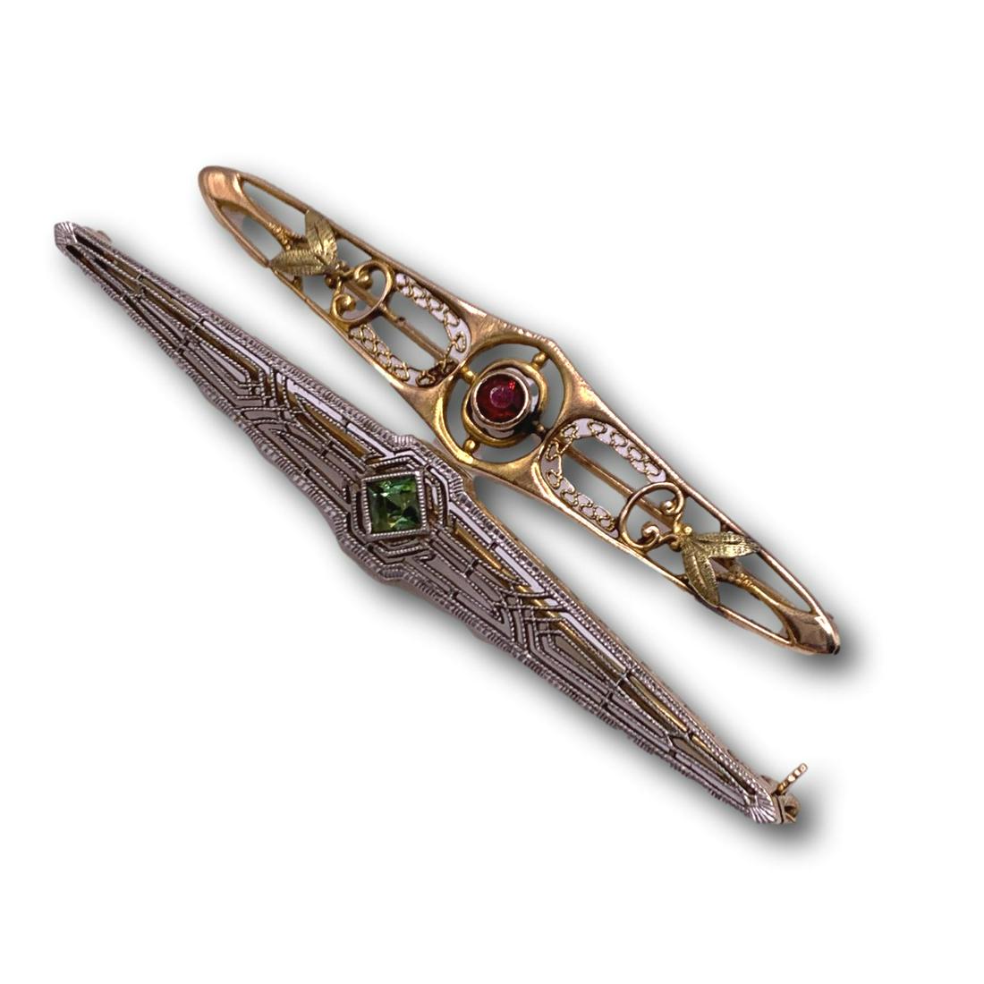 Pair of Antique Brooches - Gold & Platinum: The art deco brooch with green stone is marked platinum and 14K gold. The brooch with garnet stone is marked 10K. Total weight of both pieces is 5.5 grams. The platinum/14K brooch is slightly longer t