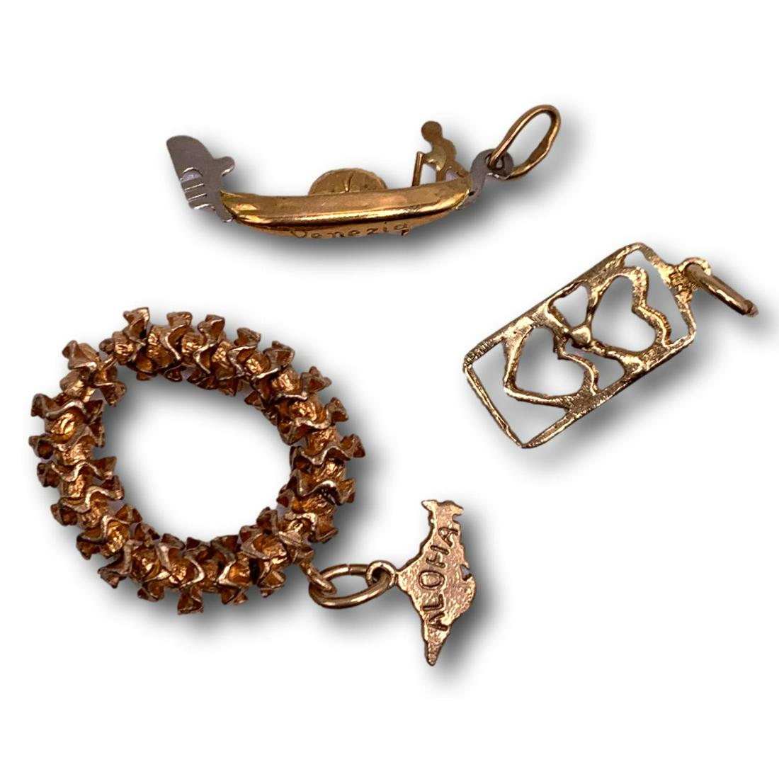 Three Vintage Gold Charms - 14K and 18K - Hawaiian Lei, Gondola & Hearts: Gondola charm is marked 750, measures 7/8 inches long and weighs less than 1/2 gram. The Hawaiian Lei and Heart charms are marked 14K with a combined weight of 4.8 grams. The lei measures 1 1/2" in le