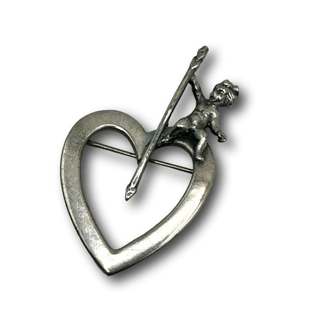 Cini Sterling Silver Cupid on Heart Pin Brooch: PICKUP AND SHIPPING Local pickup is available in Glenview, IL by appointment. The address will be provided on your invoice at checkout. In-House shipping is available for this lot at a flat rate via U