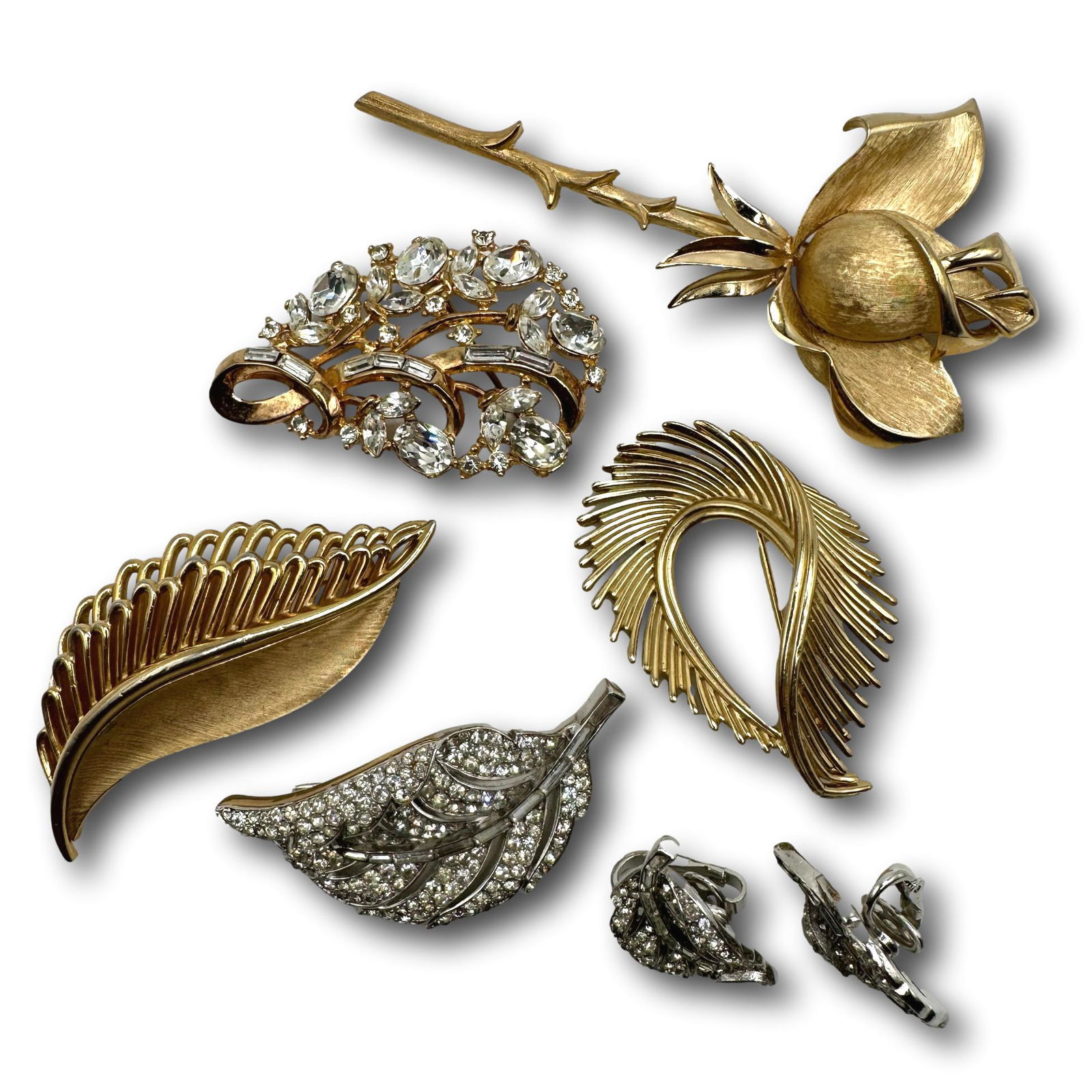 Group of Trifari Brooches and Earrings: PICKUP AND SHIPPING Local pickup is available in Glenview, IL by appointment. The address will be provided on your invoice at checkout. In-House shipping is available for this lot at a flat rate via U