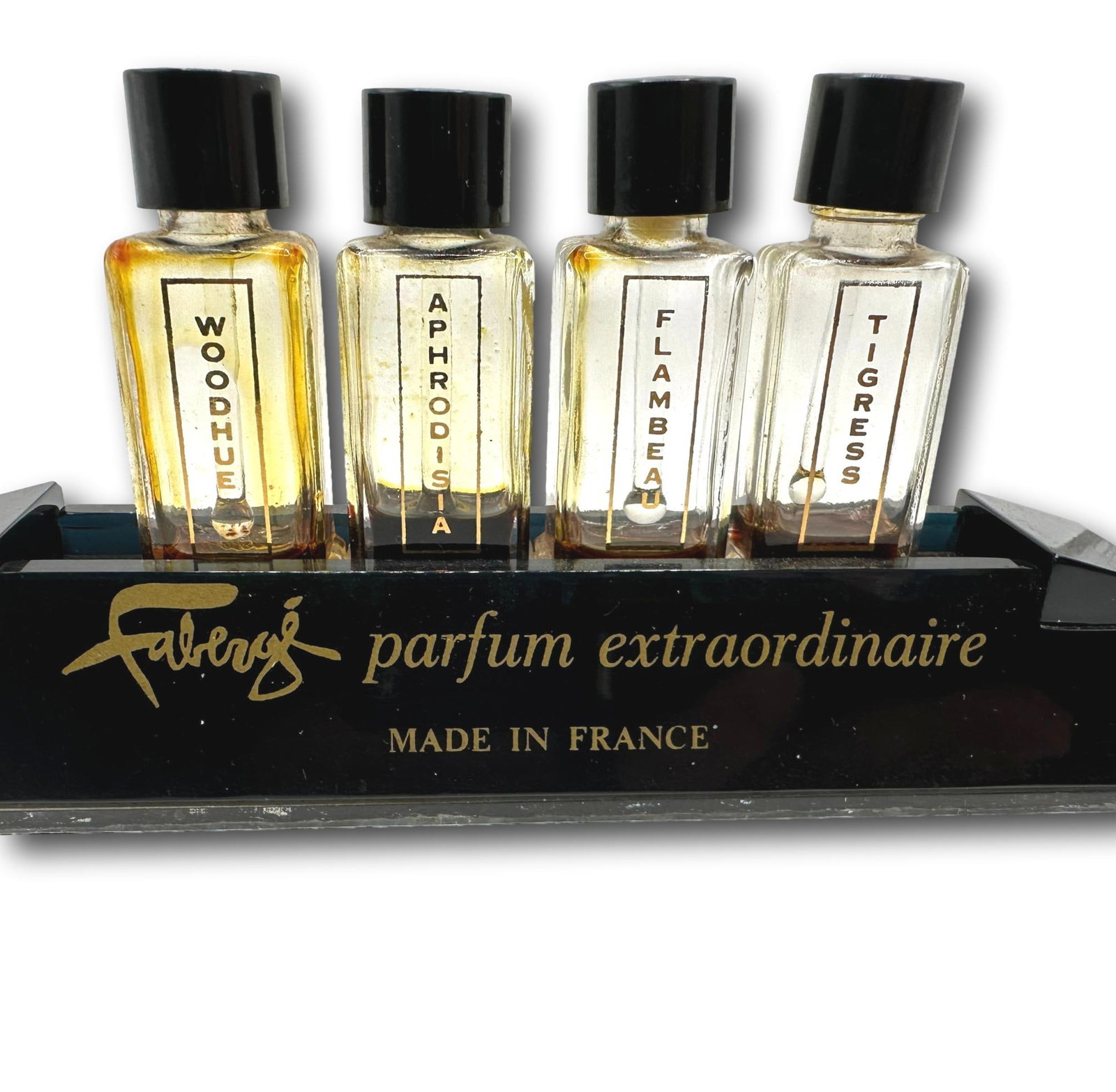 Vintage Faberge Display Perfume Tester: Faberje tester display contains four bottles that are mostly empty due to use and evaporation. Display shows some minor wear. Please refer to the photos for details. Most items are used or vintage and