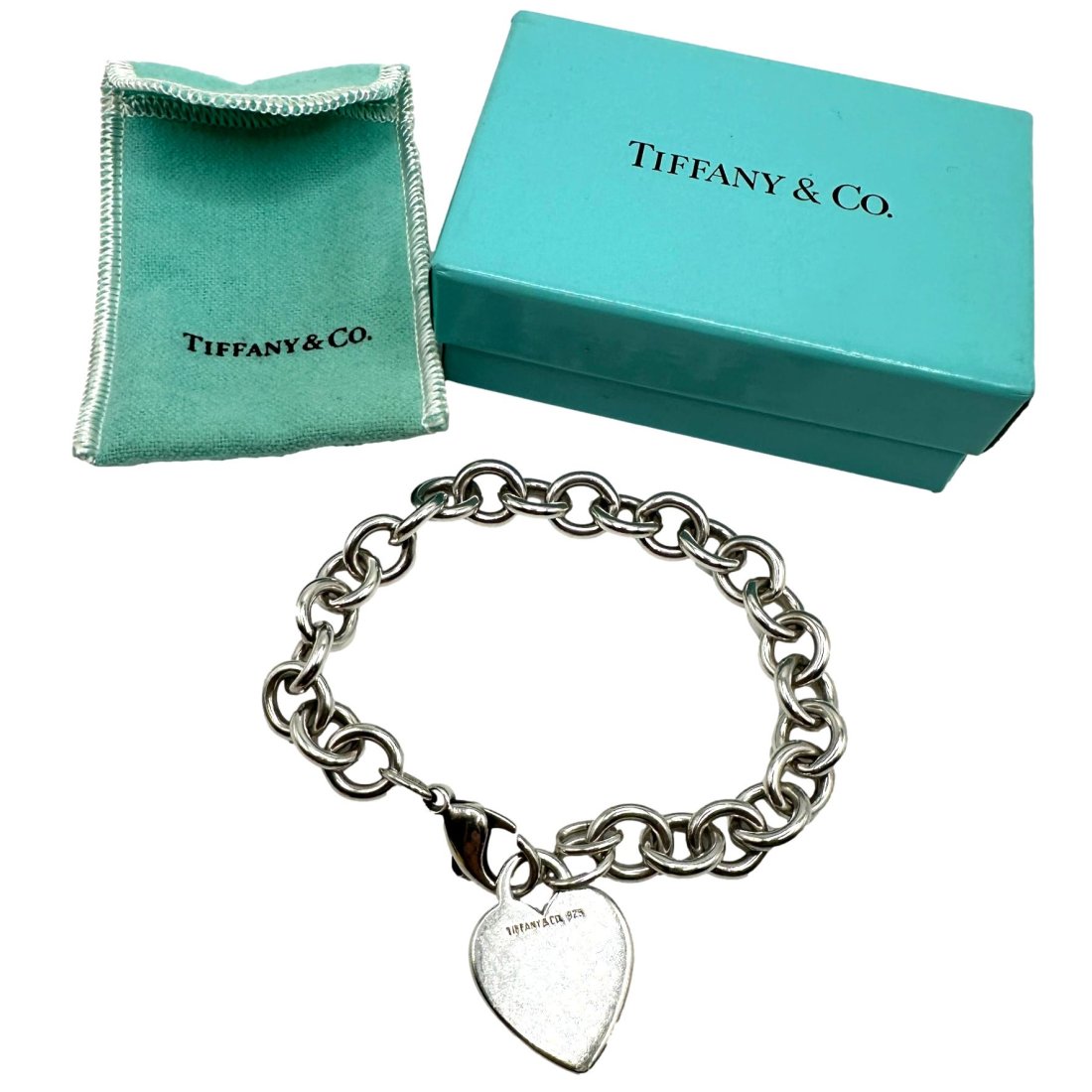 Tiffany & Co Sterling Silver Heart Bracelet: Measures approximately 8" in length. Weighs 34 grams. Comes with box and pouch.
