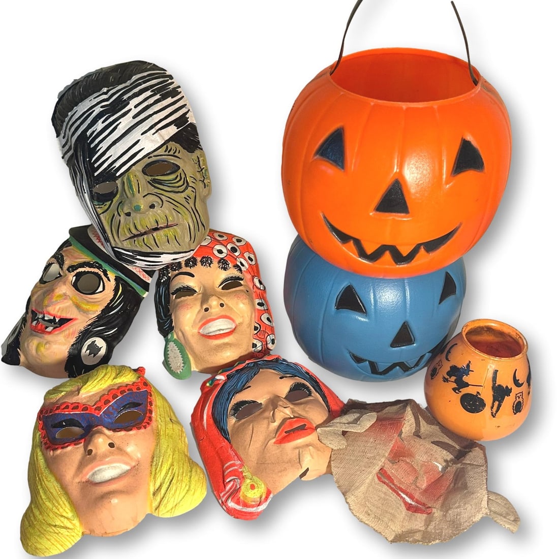 Lot of Vintage Halloween Masks and Jack-O-Lantern Candy Buckets: Masks show signs of wear with slight cracks. All lots in this auction come from a lifetime of collecting Halloween and Christmas memorabilia. Our collector has amassed some of the rarest and hard to f