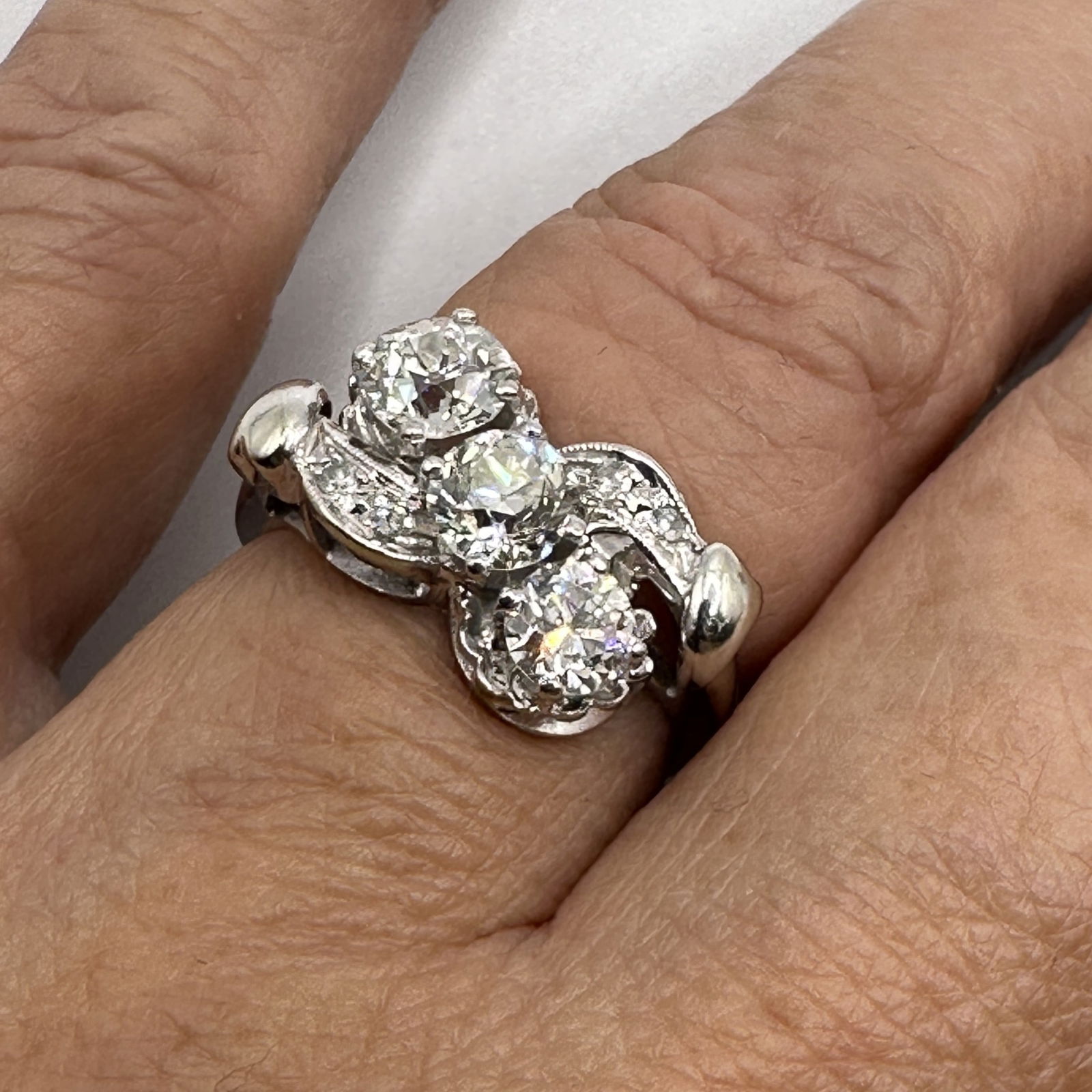 Vintage Multi-Diamond Ring in 14K Setting: Approximately 1.25 total carat weight. Three larger diamonds flank the center of the ring, each with a clarity of VS2. The first stone is a transitional cut and the other two stones are European cut.