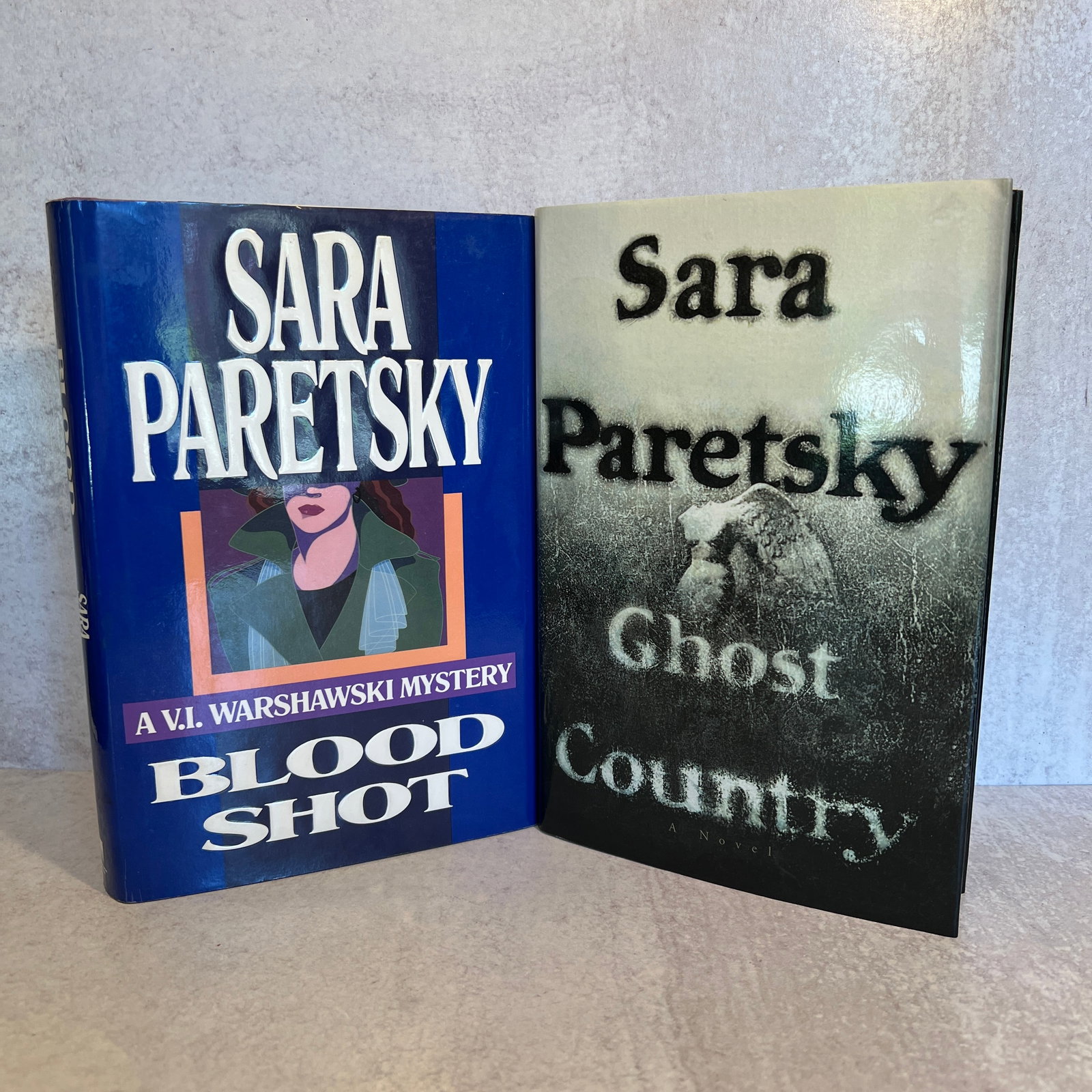 Sara Paretsky Autographed Blood Shot, and Ghost Country: Includes: Blood Shot - copyright 1988, and Ghost Country - copyright 1998- both signed by the author. Refer to photos for additional condition information as they are a part of the description. Please